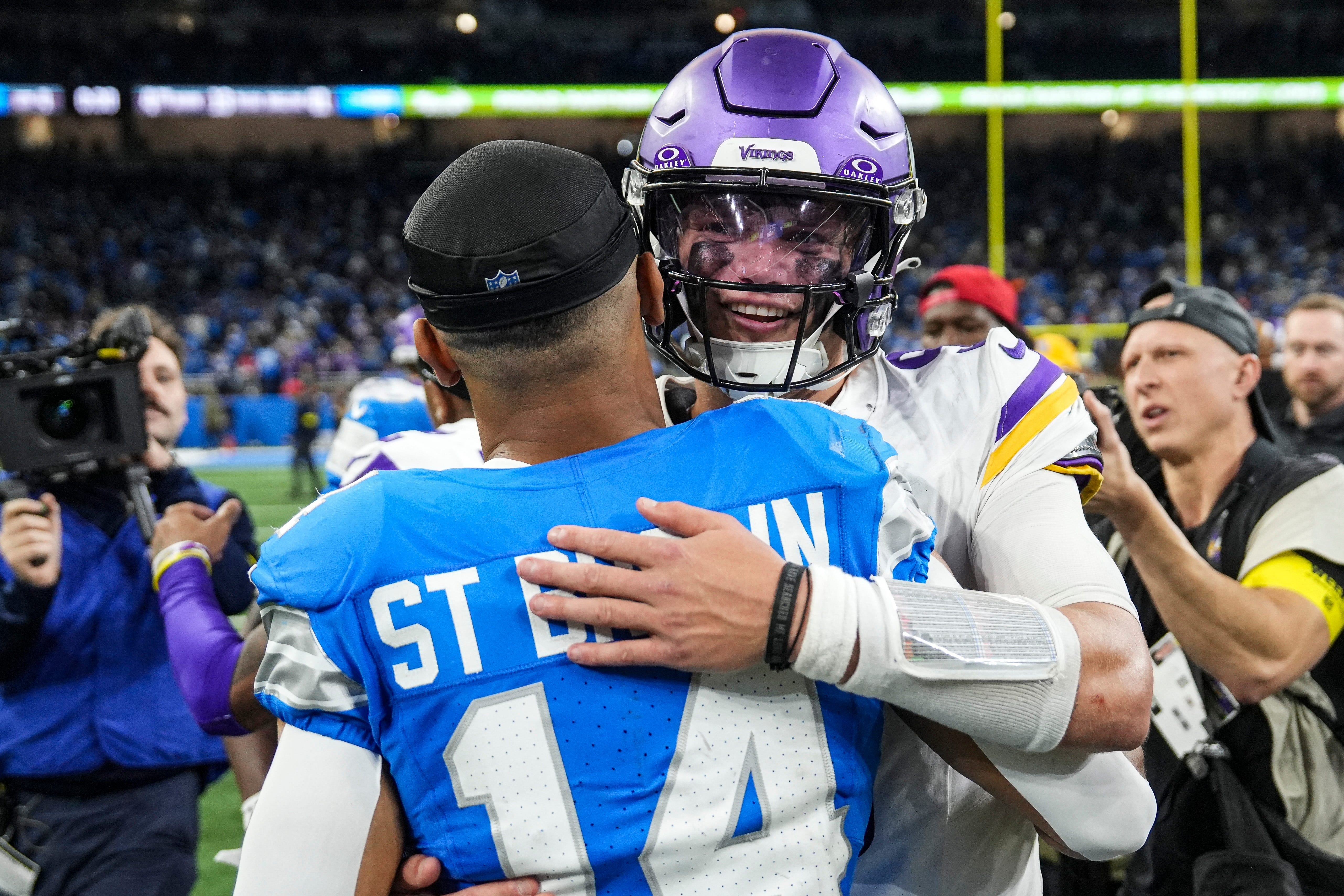 Minnesota Vikings quarterback J.J. McCarthy (9 hugs Detroit Lions wide receiver Amon-Ra St. Brown (14) after 27-24 win over Detroit Lions at Ford Field in Detroit on Sunday, November 2, 2025.