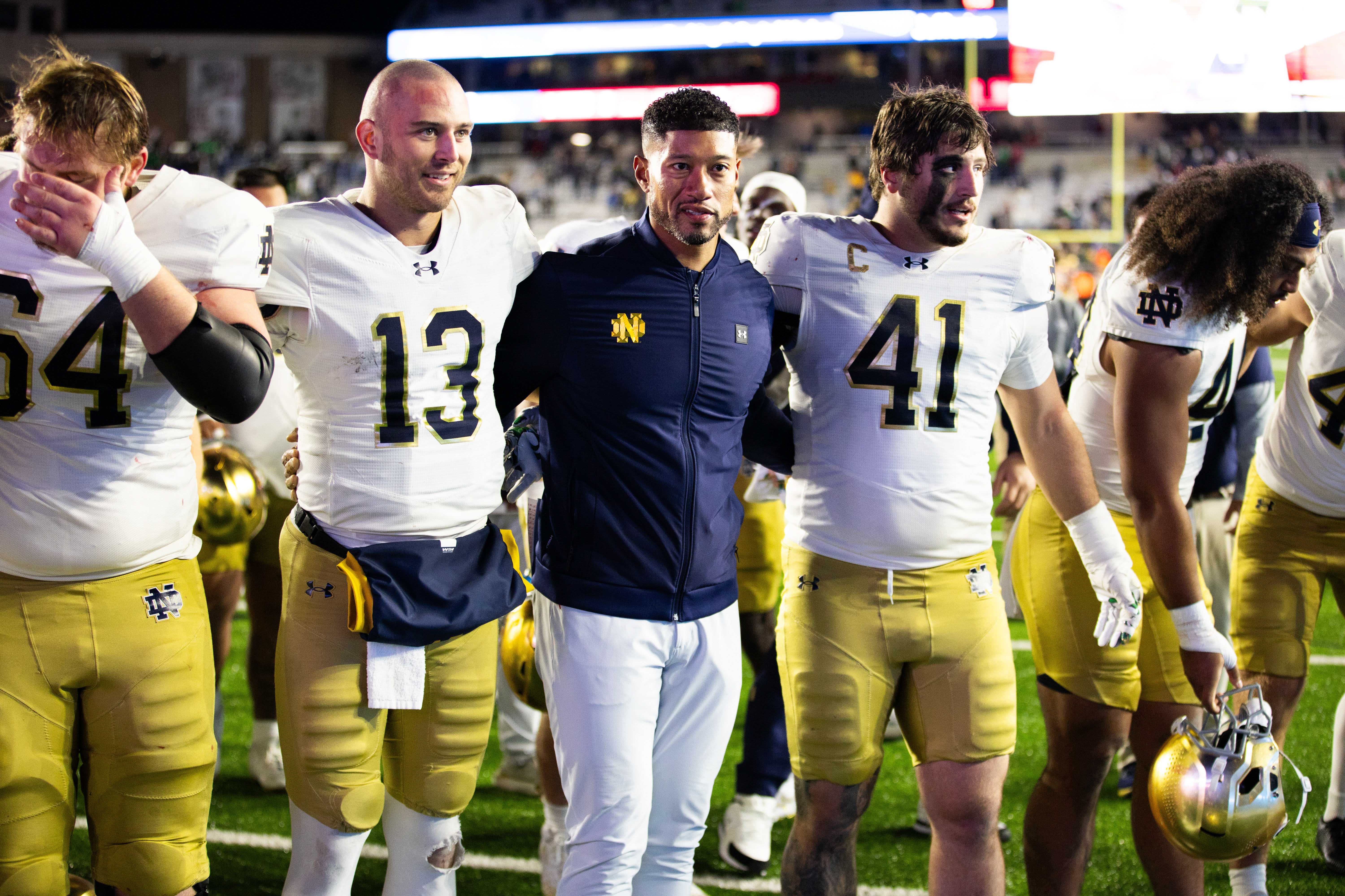 Nov 1, 2025; Chestnut Hill, Massachusetts, USA; Notre Dame Fighting Irish head coach Marcus Freeman, Notre Dame Fighting Irish quarterback CJ Carr (13) and Notre Dame Fighting Irish defensive lineman Donovan Hinish (41) after the game against the Boston College Eagles at Alumni Stadium. Mandatory Credit: Edward Finan-Imagn Images