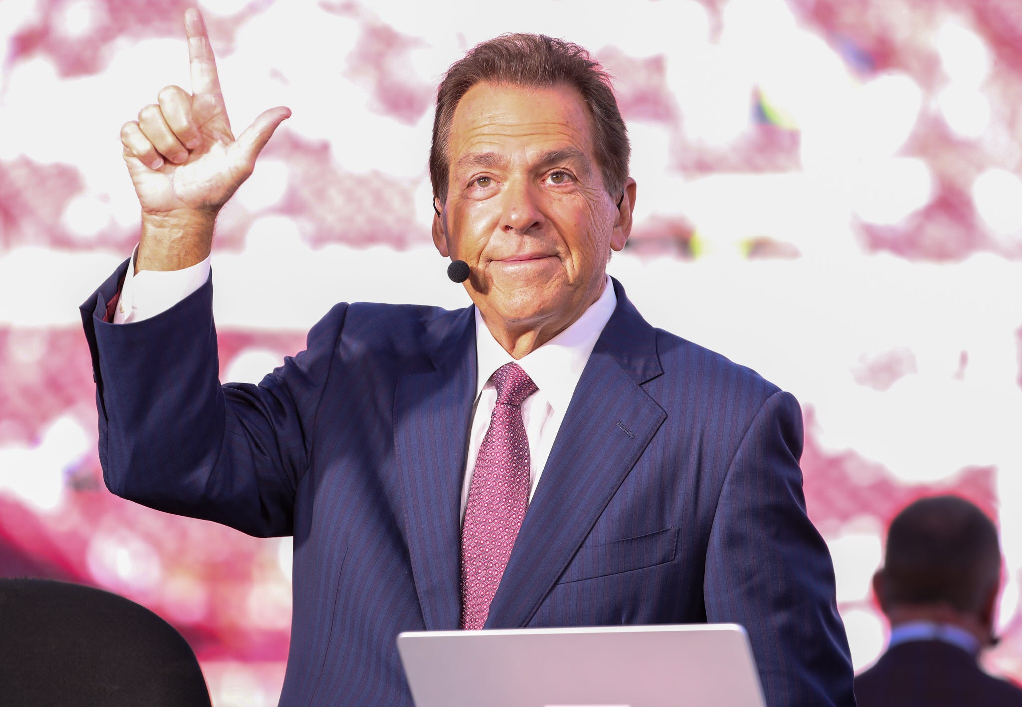 ESPN personality Nick Saban does the Guns Up gesture toward Texas Tech students before a Big 12 Conference football game, Saturday, Nov. 8, 2025, at Jones AT&T Stadium.