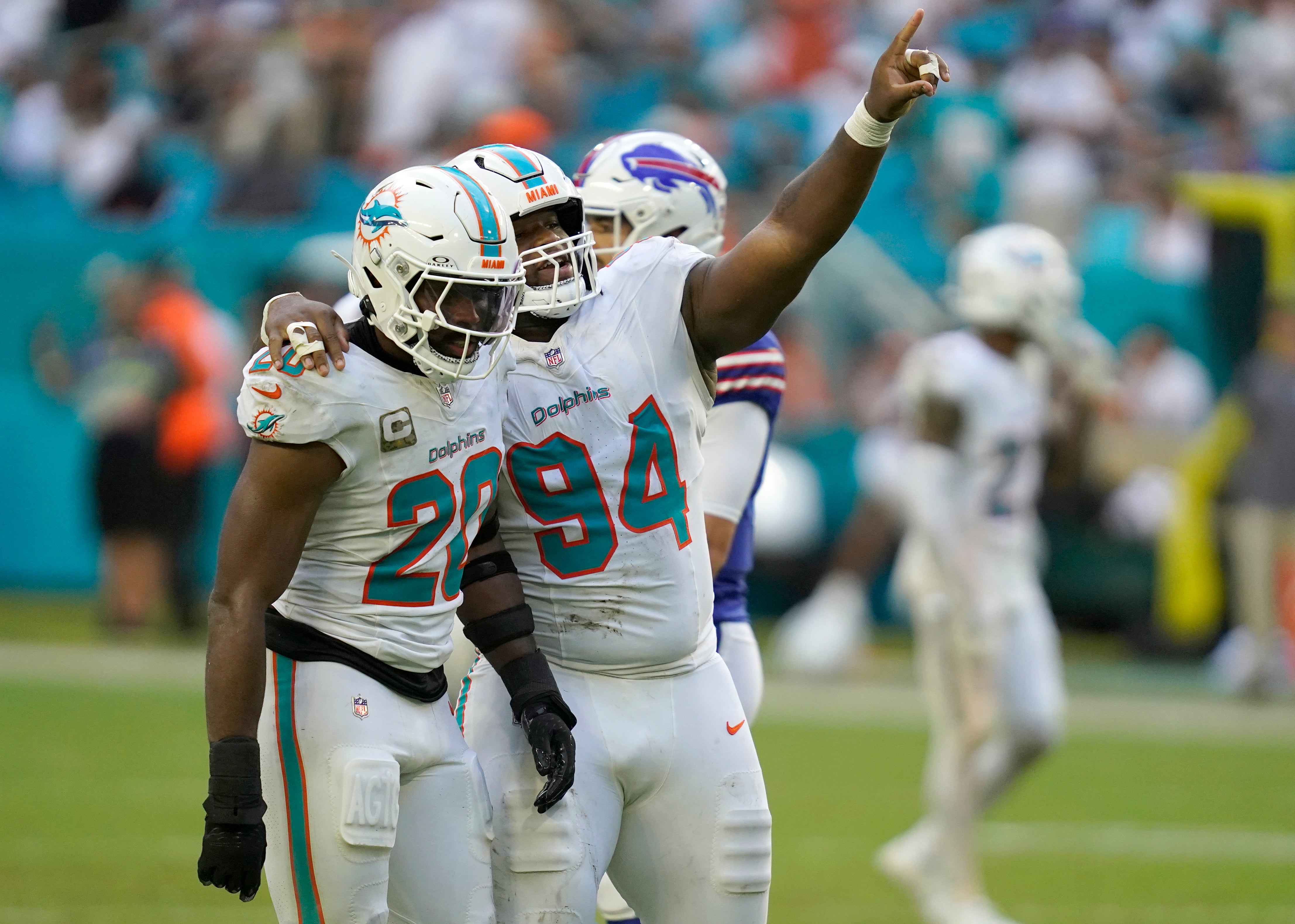 Nov 9, 2025; Miami Gardens, Florida, USA; Miami Dolphins linebacker Jordyn Brooks (20) and defensive tackle Jordan Phillips (94) celebrate during the second half against the Buffalo Bills at Hard Rock Stadium.