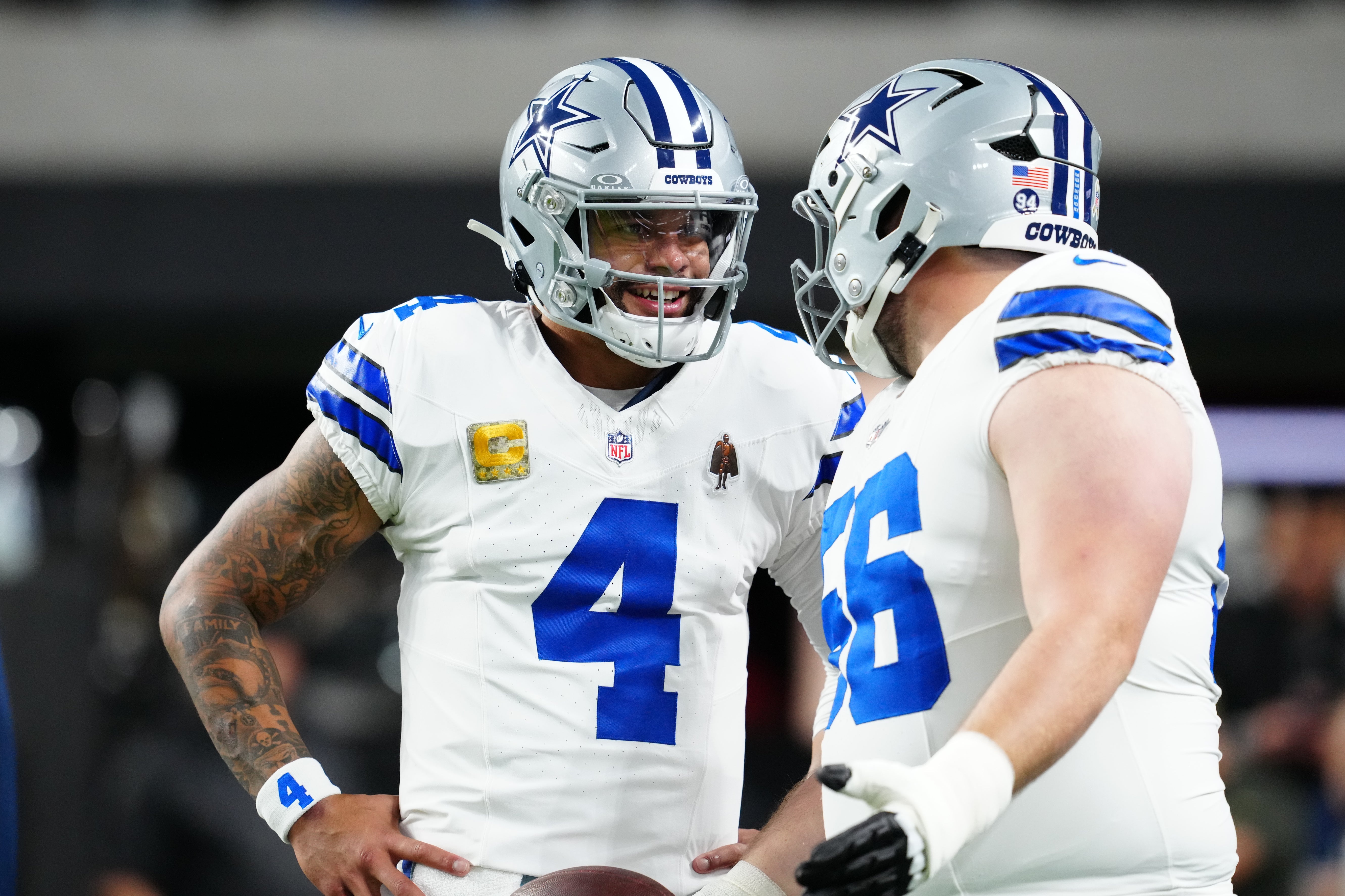 Nov 17, 2025; Paradise, Nevada, USA; Dallas Cowboys quarterback Dak Prescott (4) and center Cooper Beebe (56) warm up prior to a game against the Las Vegas Raiders at Allegiant Stadium.