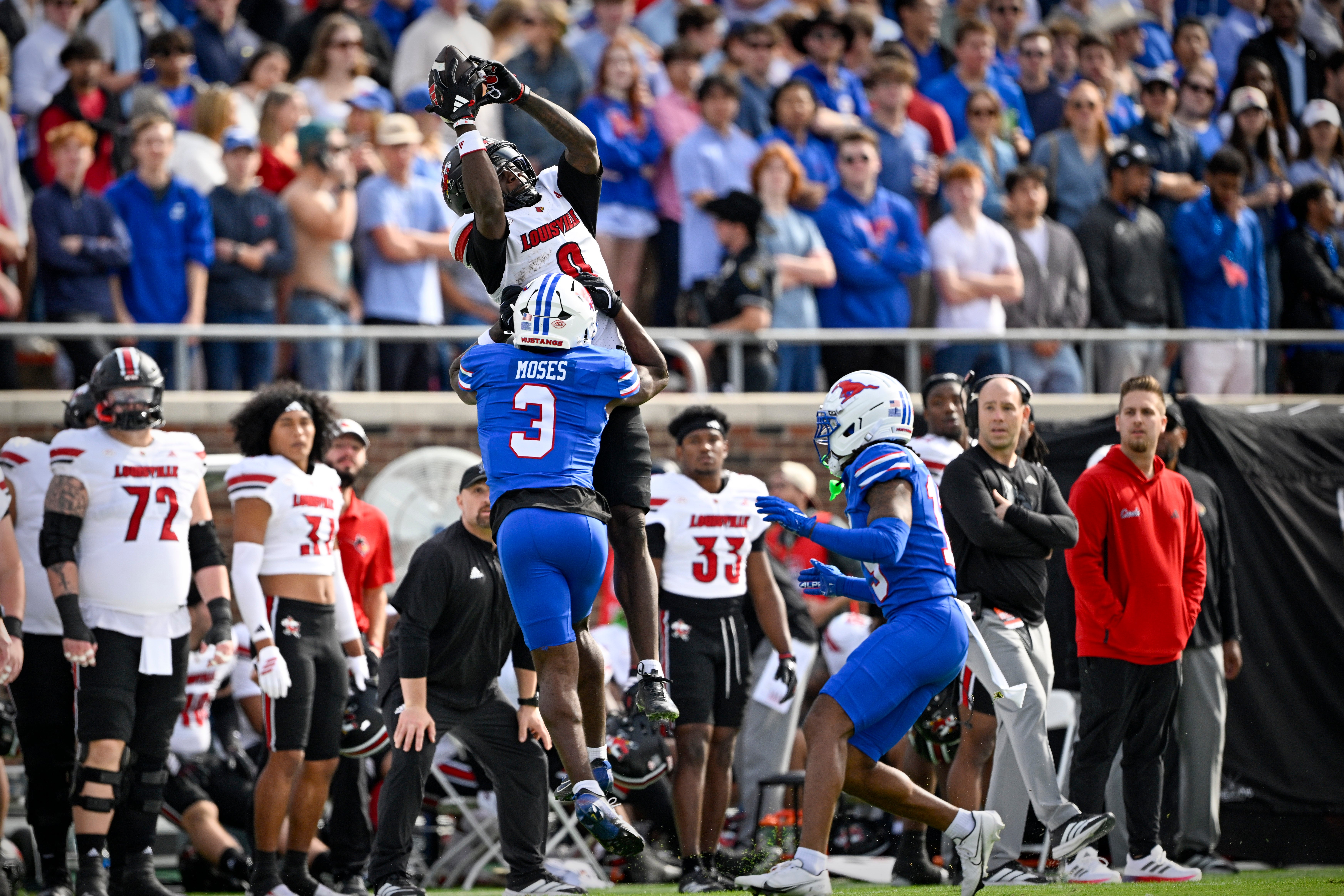 Nov 22, 2025; Dallas, Texas, USA; Louisville Cardinals wide receiver Chris Bell (0) catches a pass over SMU Mustangs safety Ahmaad Moses (3) during the first half at Gerald J. Ford Stadium. Mandatory Credit: Jerome Miron-Imagn Images