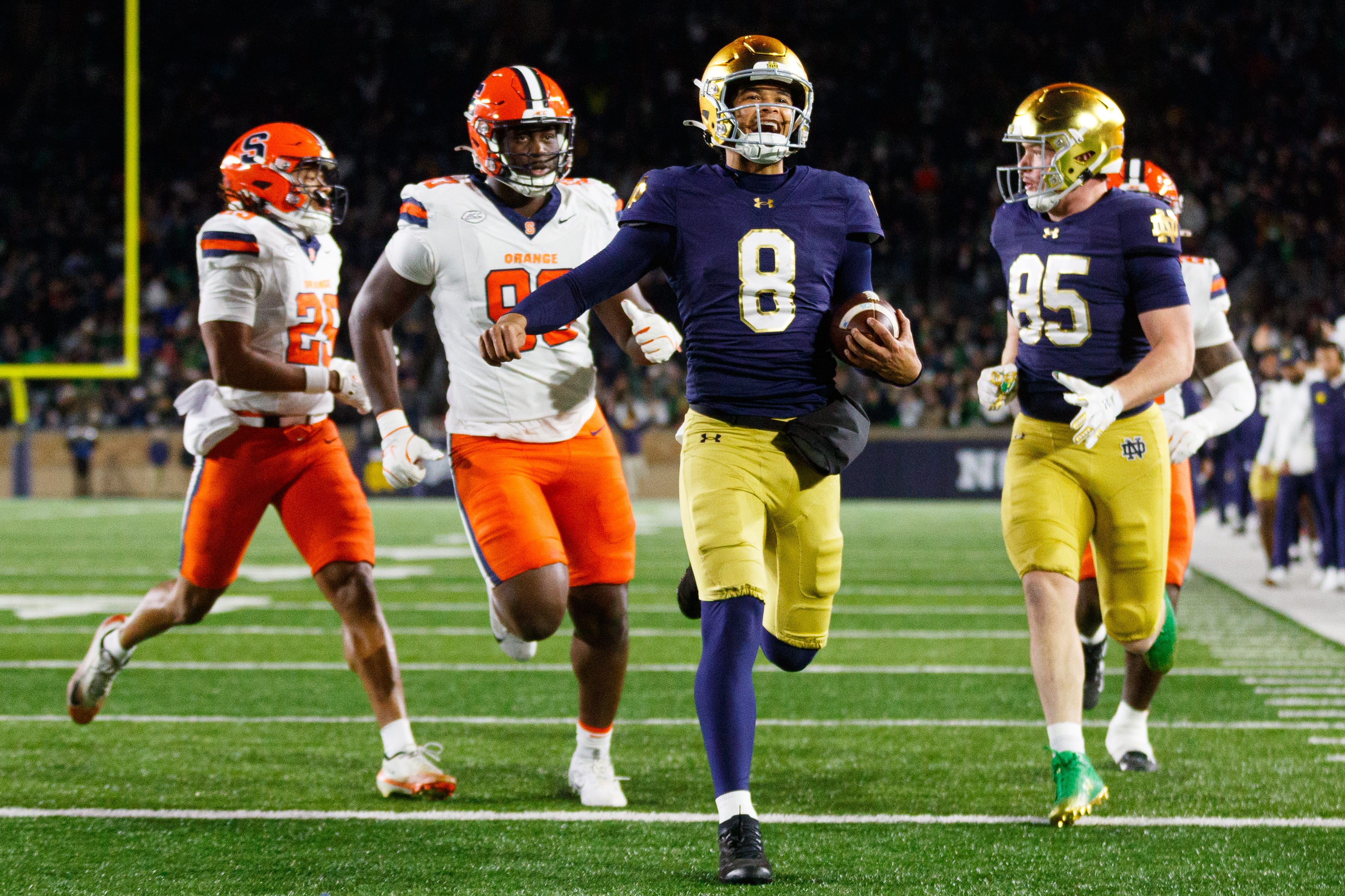 Notre Dame quarterback Kenny Minchey (8) runs the ball into the end zone for a touchdown in the second half of a NCAA football game against Syracuse at Notre Dame Stadium on Saturday, Nov. 22, 2025, in South Bend.
