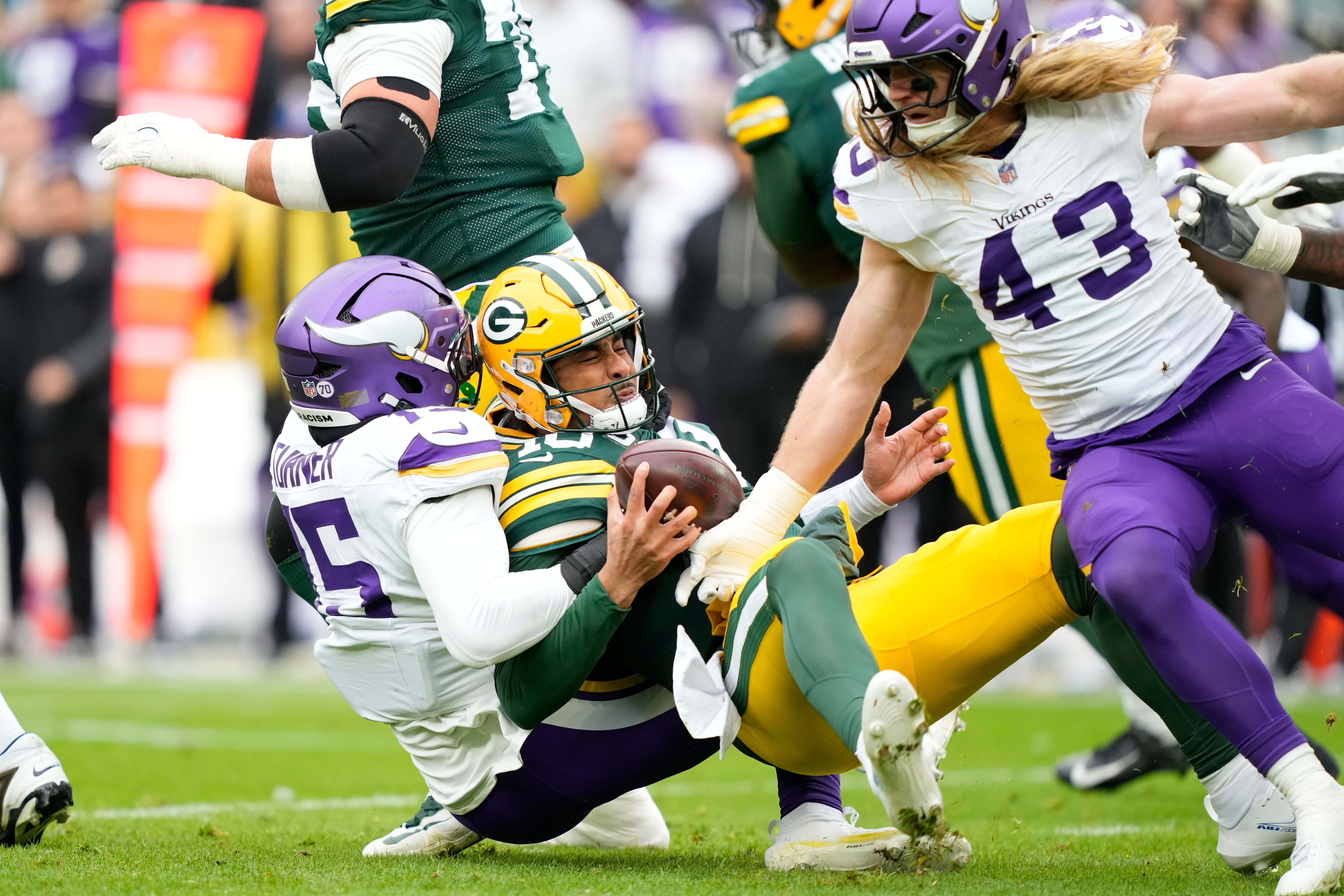 Nov 23, 2025; Green Bay, Wisconsin, USA; Green Bay Packers quarterback Jordan Love (10) is sacked by Minnesota Vikings linebacker Dallas Turner (15) during the first half at Lambeau Field.