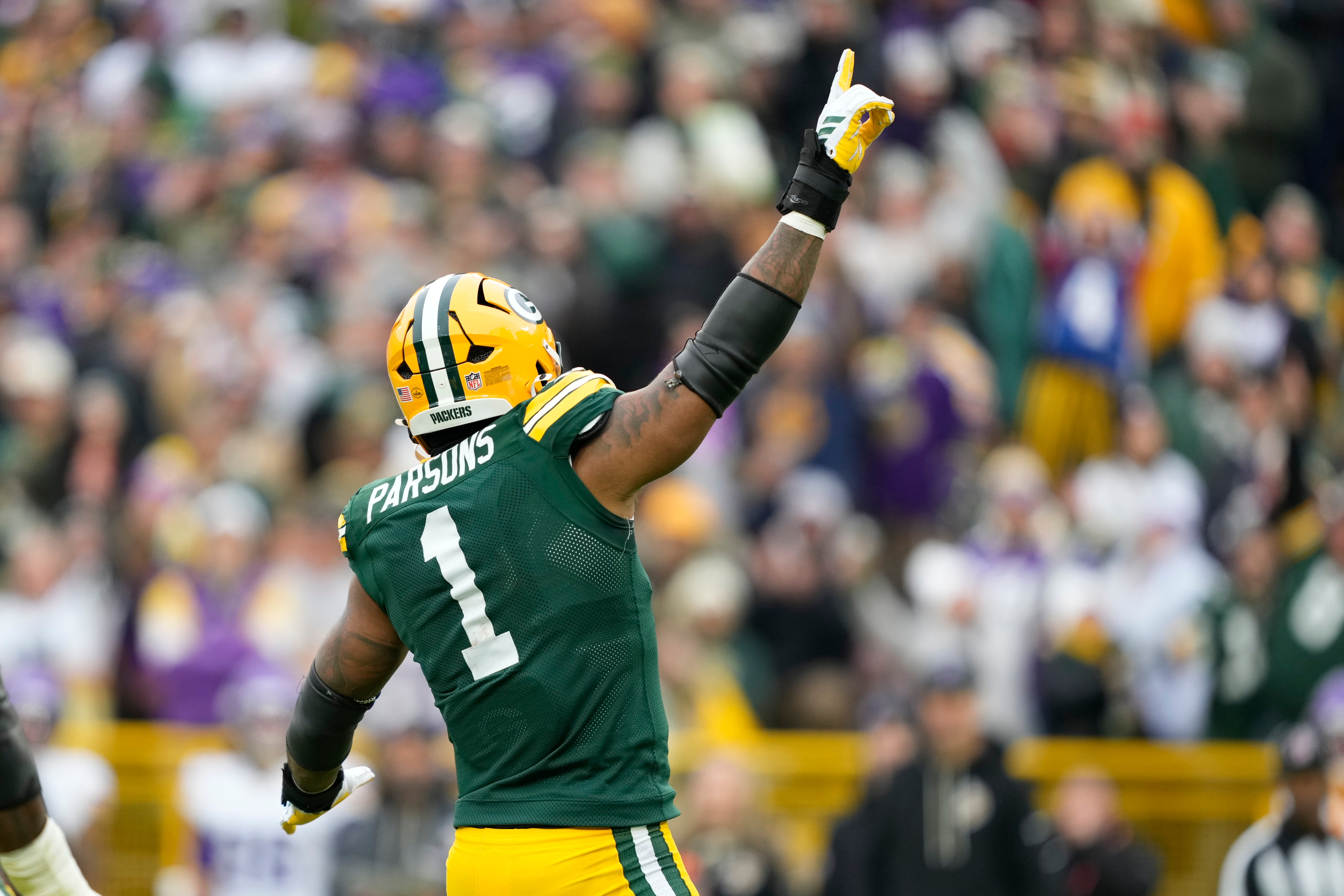 Nov 23, 2025; Green Bay, Wisconsin, USA; Green Bay Packers defensive end Micah Parsons (1) reacts after a sack against the Minnesota Vikings during the second half at Lambeau Field.