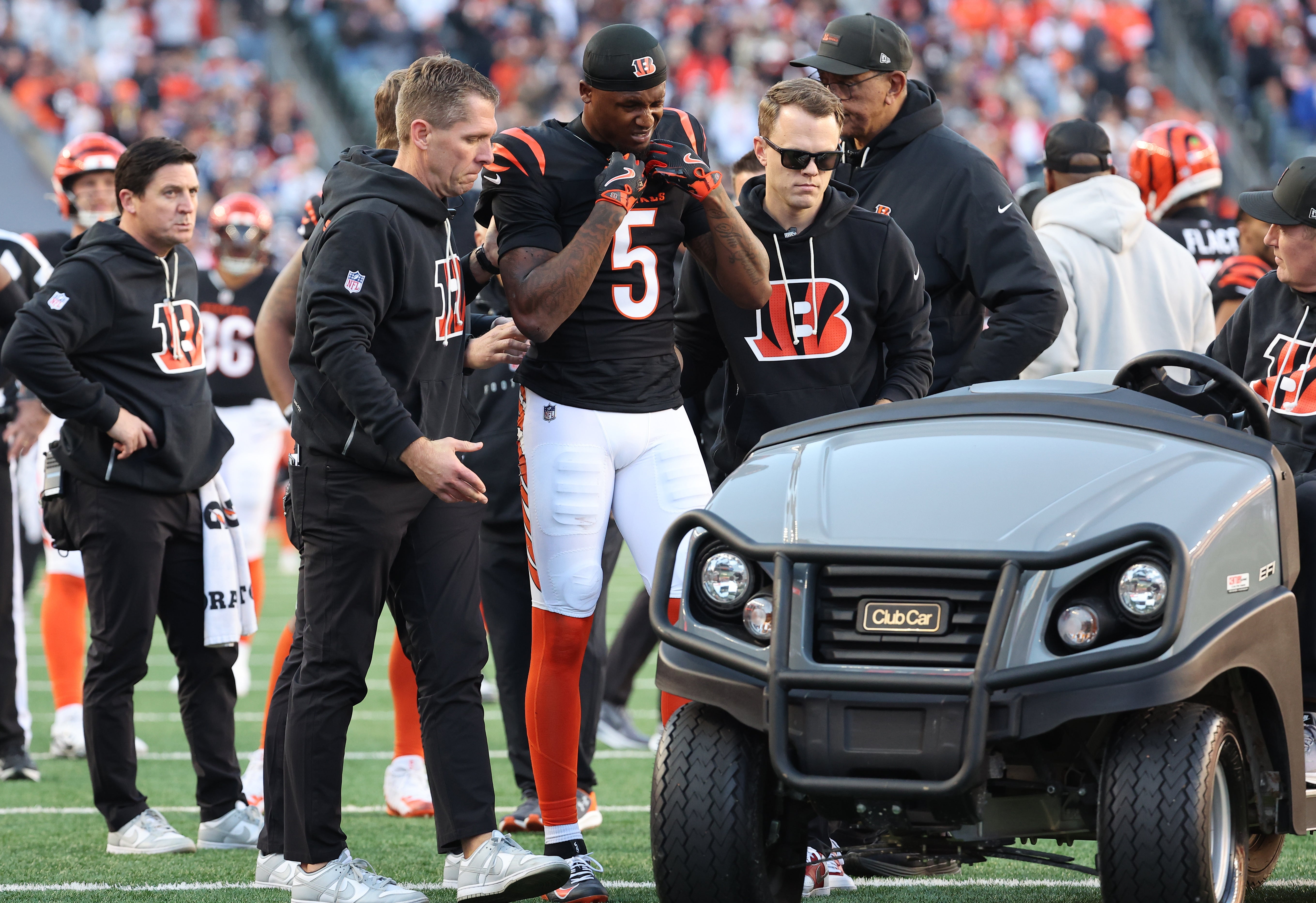 Nov 23, 2025; Cincinnati, Ohio, USA; Cincinnati Bengals wide receiver Tee Higgins (5) is helped to a cart after an injury during the second half against the New England Patriots at Paycor Stadium.