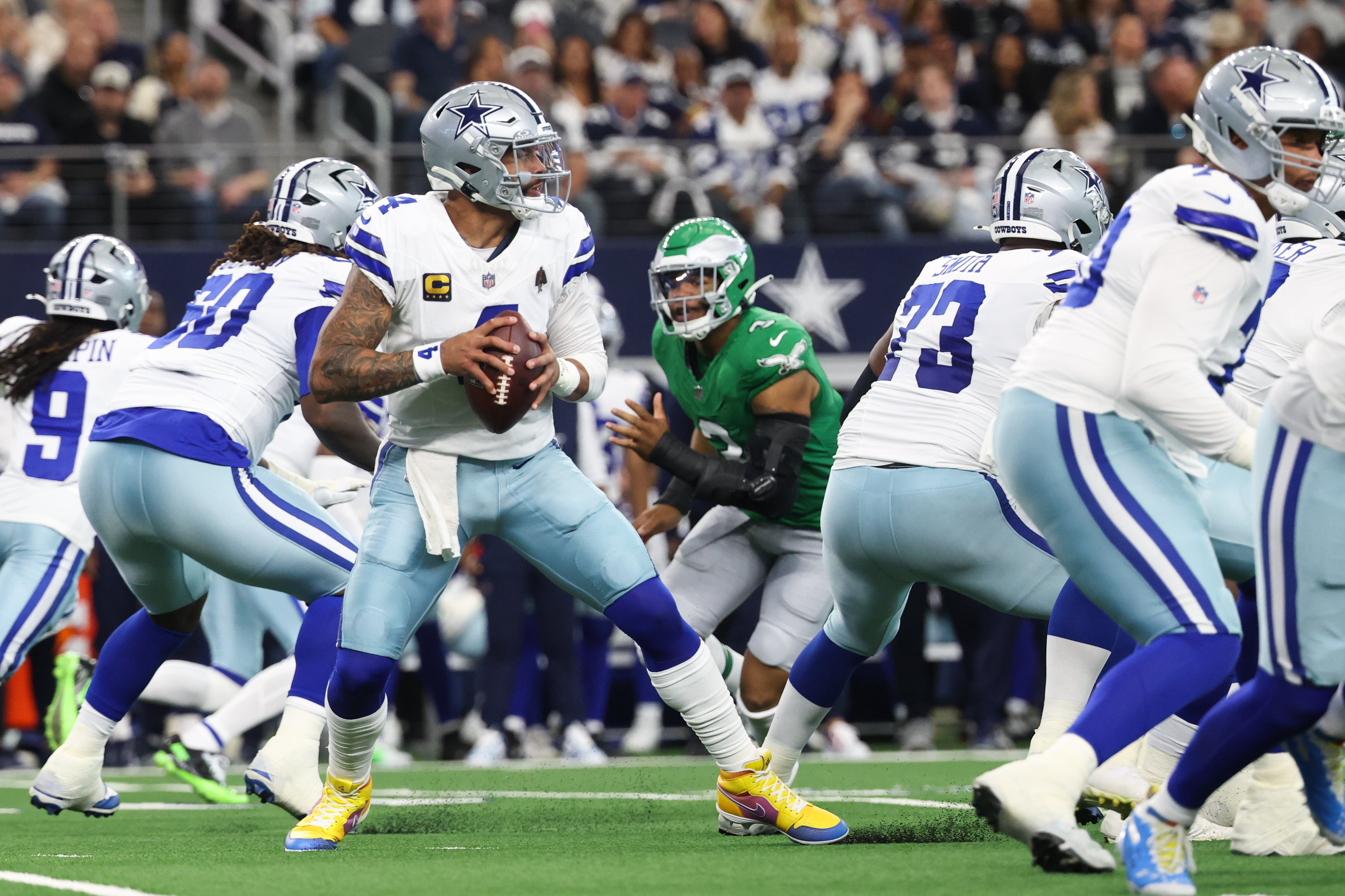 Nov 23, 2025; Arlington, Texas, USA; Dallas Cowboys quarterback Dak Prescott (4) looks to throws during the first quarter against the Philadelphia Eagles at AT&T Stadium.