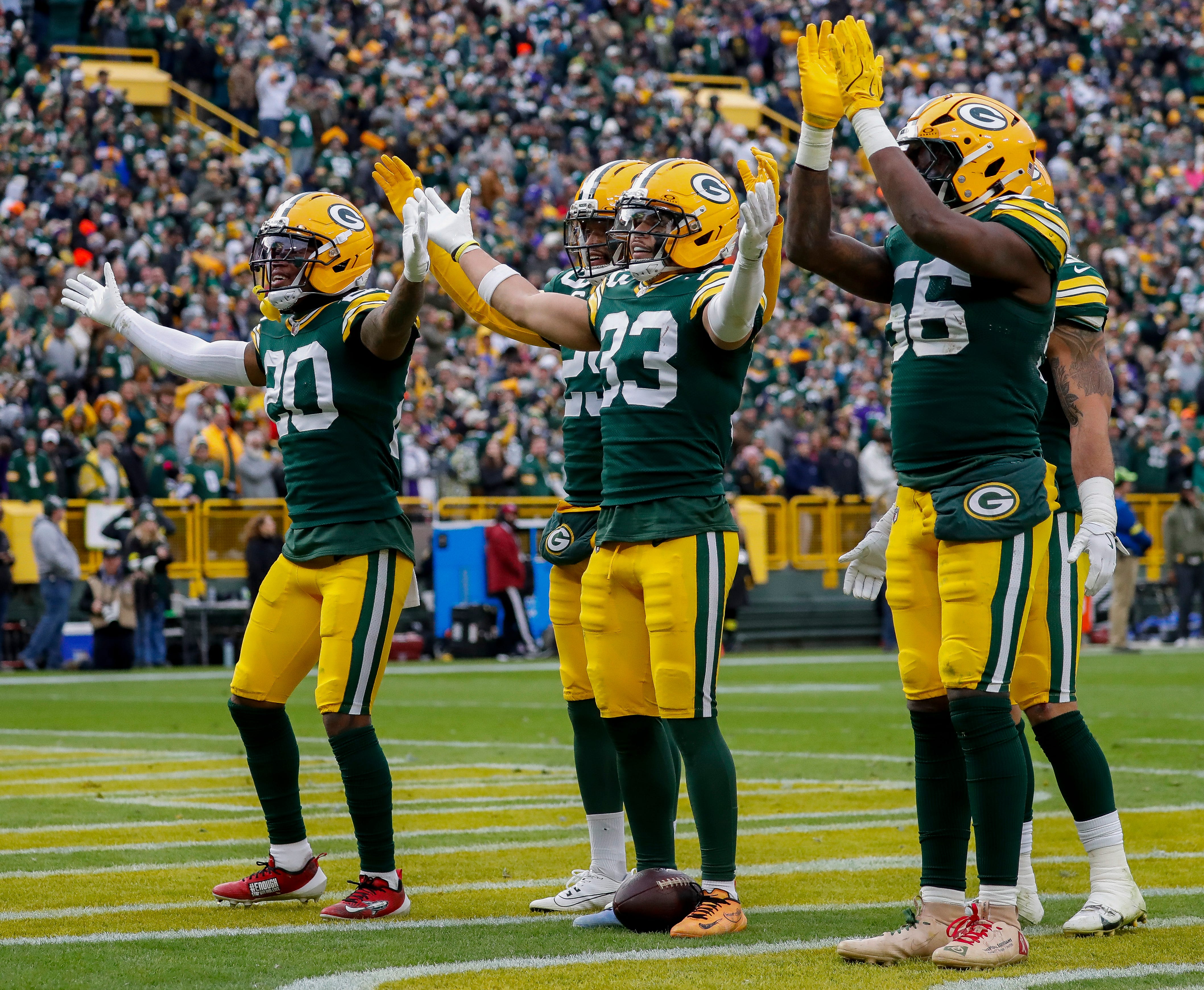 Green Bay Packers safeties Javon Bullard (20), Evan Williams (33), and Xavier McKinney (29) and linebacker Edgerrin Cooper (56) lead Packers fans in a mock “Skol” chant after Williams intercepts a pass against the Minnesota Vikings on Sunday, November 23, 2025, at Lambeau Field in Green Bay, Wis. The Packers won the game, 23-6.