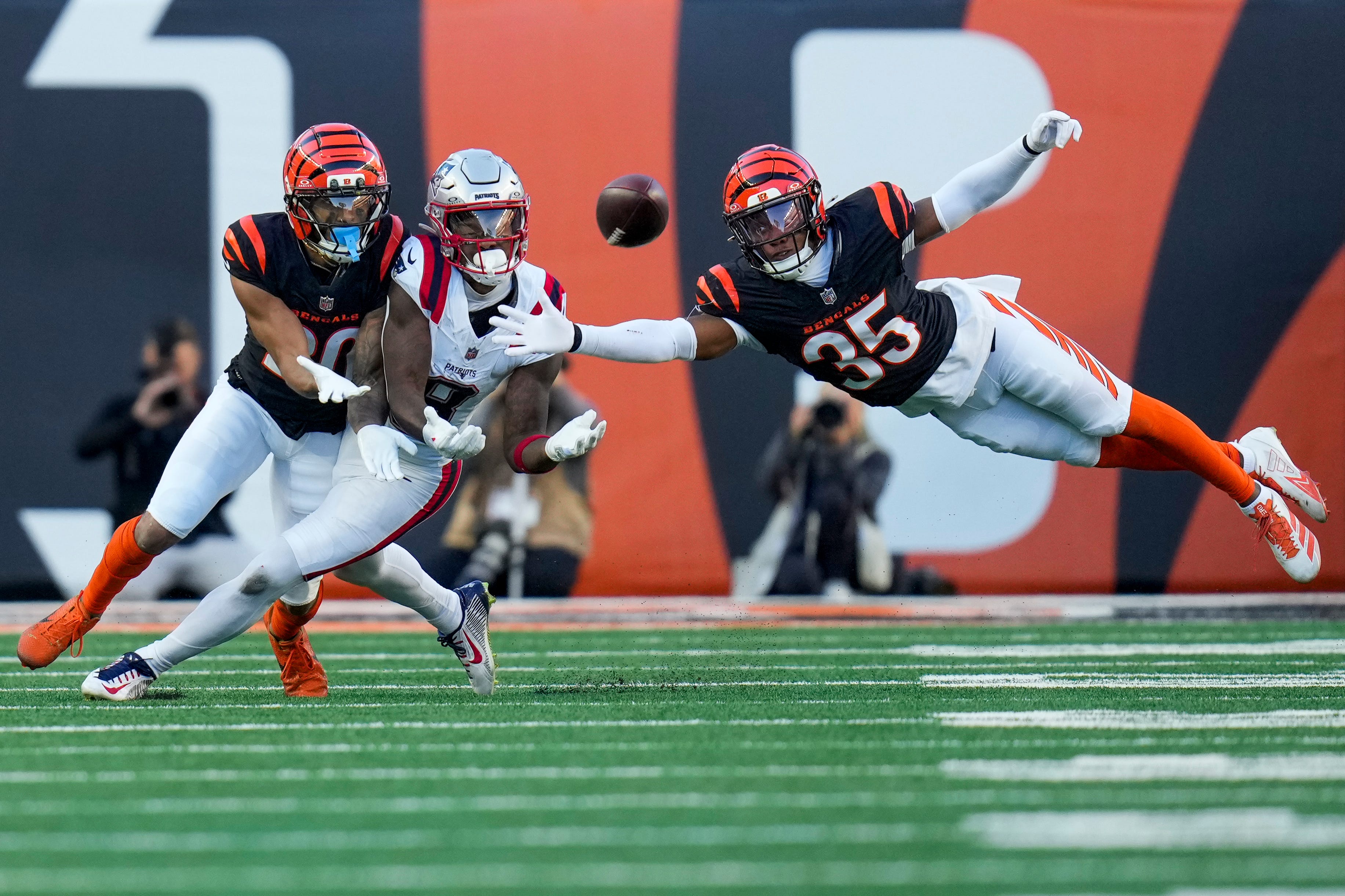 Nov 23, 2025; Cincinnati, Ohio, USA; Cincinnati Bengals cornerback Jalen Davis (35) and cornerback DJ Turner II (20) breaks up a pass to New England Patriots wide receiver Stefon Diggs (8) in the fourth quarter at Paycor Stadium.