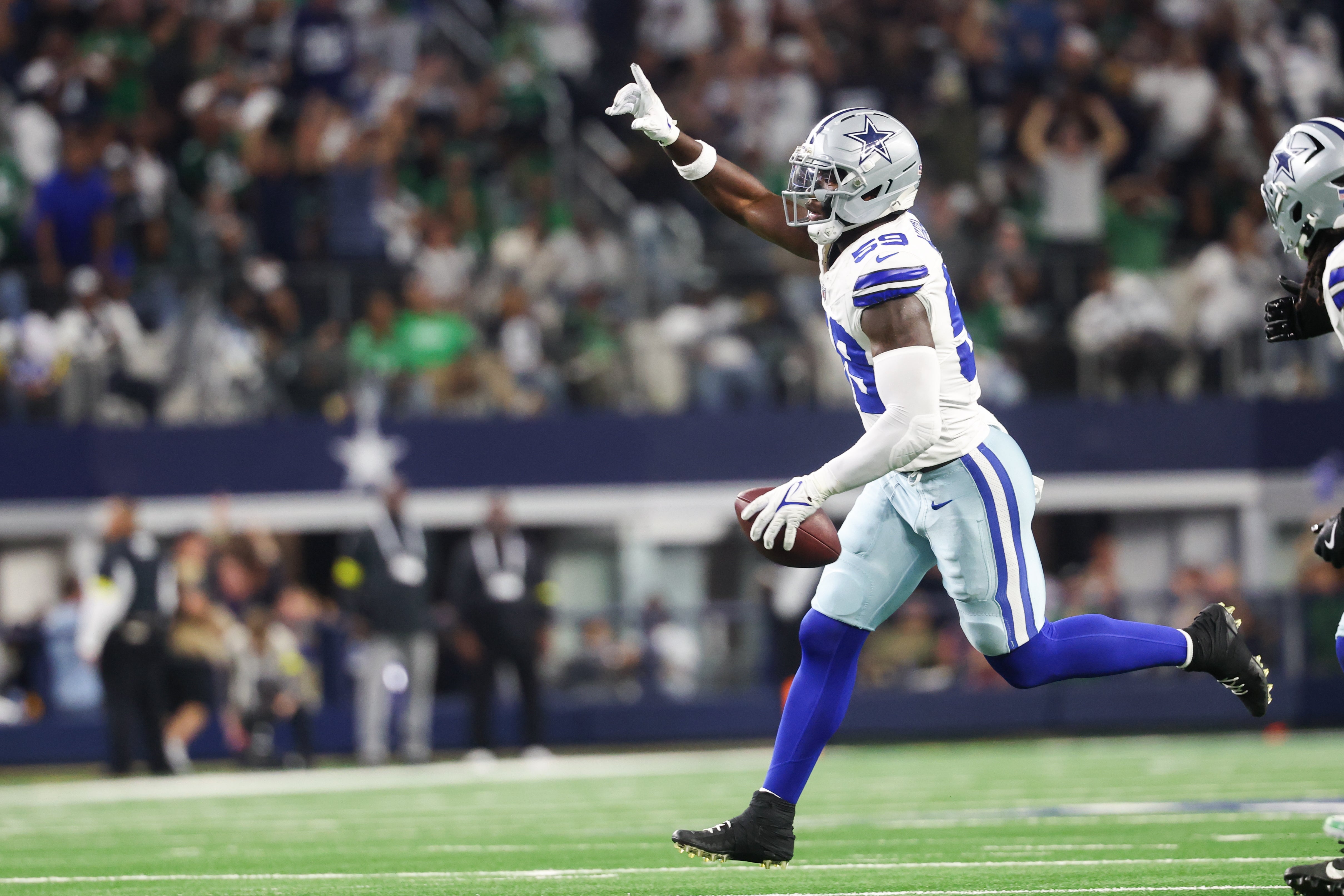 Nov 23, 2025; Arlington, Texas, USA; Dallas Cowboys linebacker Kenneth Murray, Jr. (59) reacts after retrieving a fumble in the fourth quarter against the Philadelphia Eagles at AT&T Stadium.