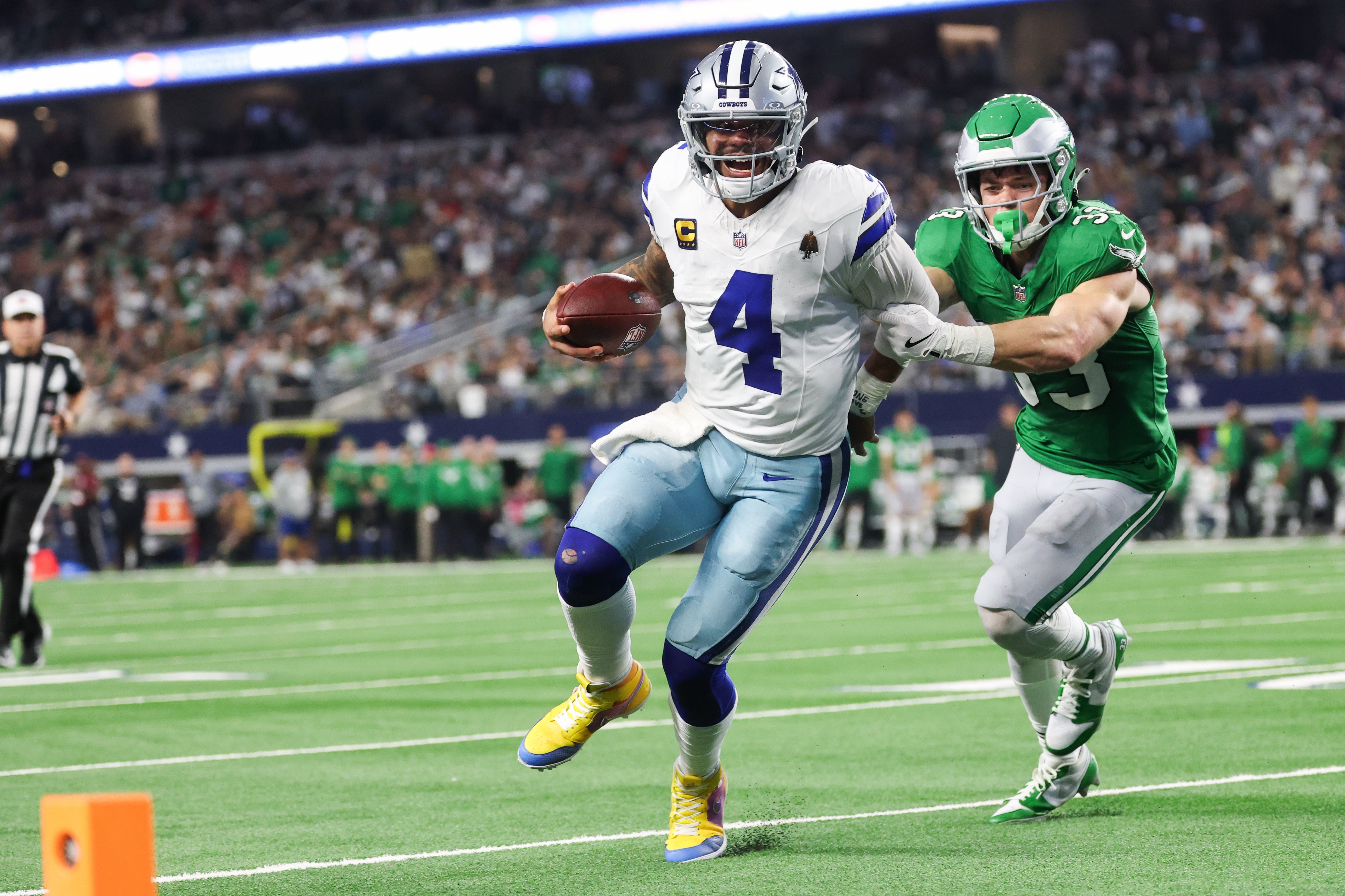 Nov 23, 2025; Arlington, Texas, USA; Dallas Cowboys quarterback Dak Prescott (4) runs with the ball in attempt to score a touchdown in the fourth quarter against the Philadelphia Eagles at AT&T Stadium.