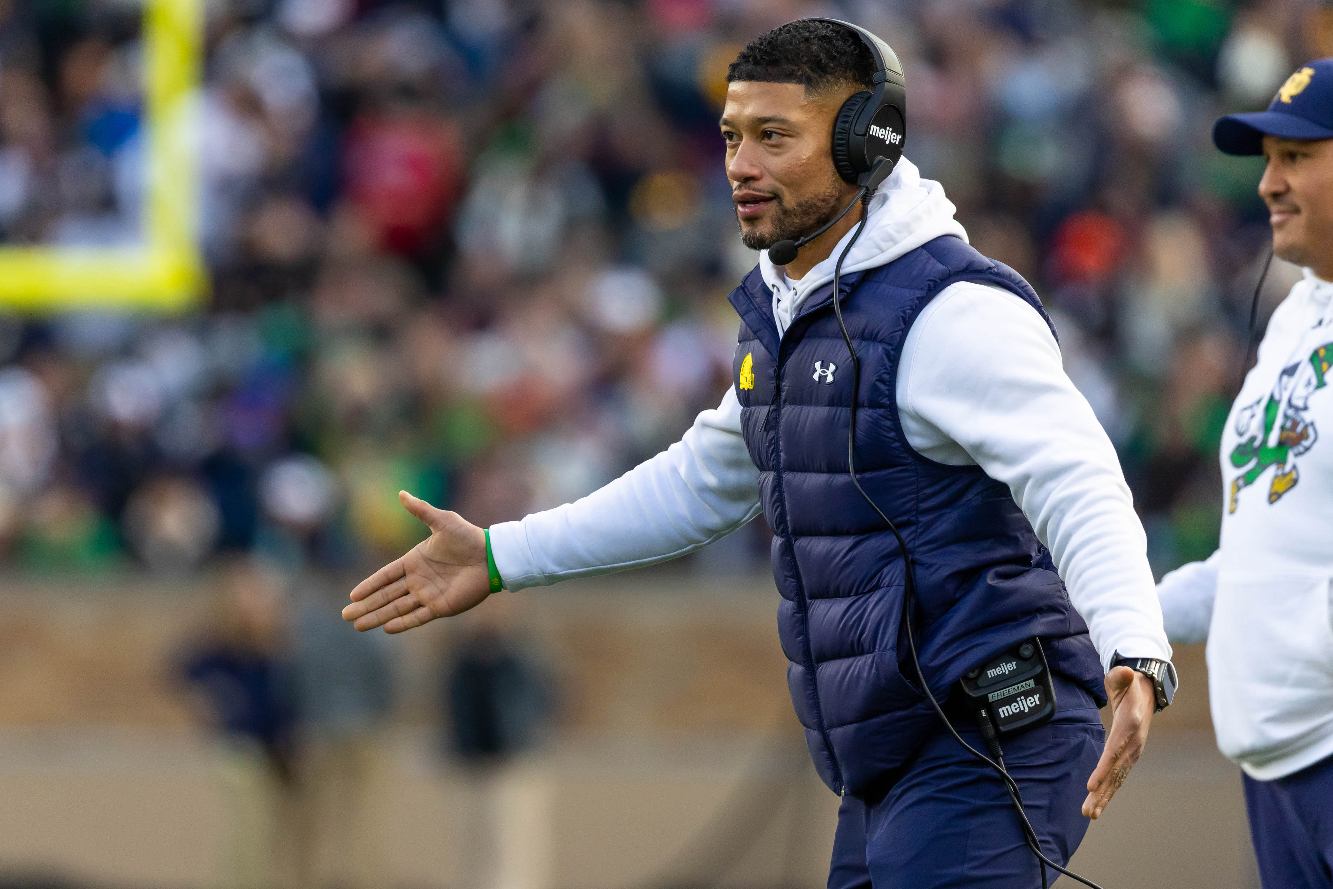 Nov 22, 2025; South Bend, Indiana, USA; Notre Dame Fighting Irish head coach Marcus Freeman celebrates with players after scoring against the Syracuse Orange during the first half at Notre Dame Stadium.