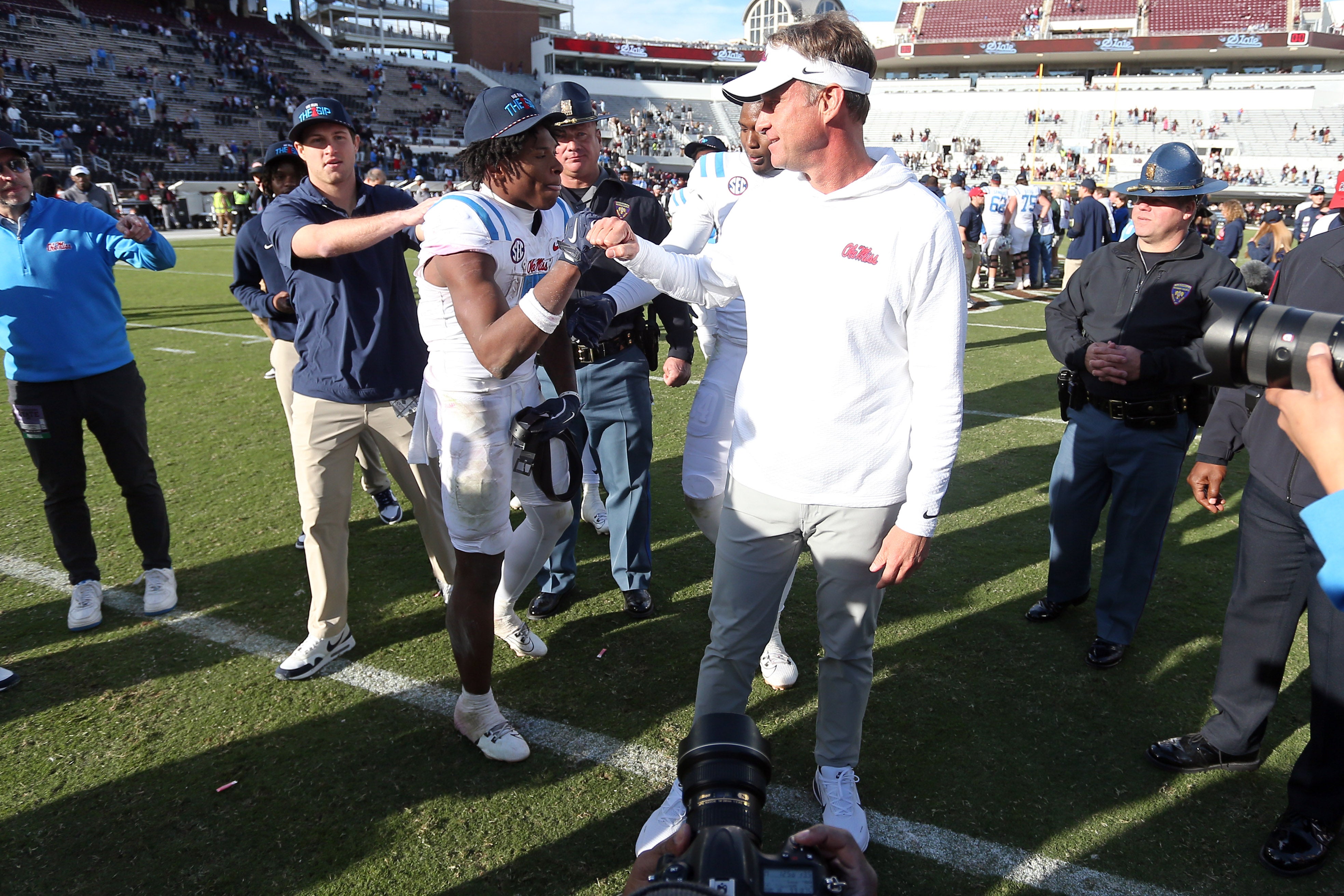 Nov 28, 2025; Starkville, Mississippi, USA; Mississippi Rebels running back Kewan Lacy (5) and head coach Lane Kiffin celebrate after defeating against the Mississippi State Bulldogs at Davis Wade Stadium at Scott Field. Mandatory Credit: Petre Thomas-Imagn Images