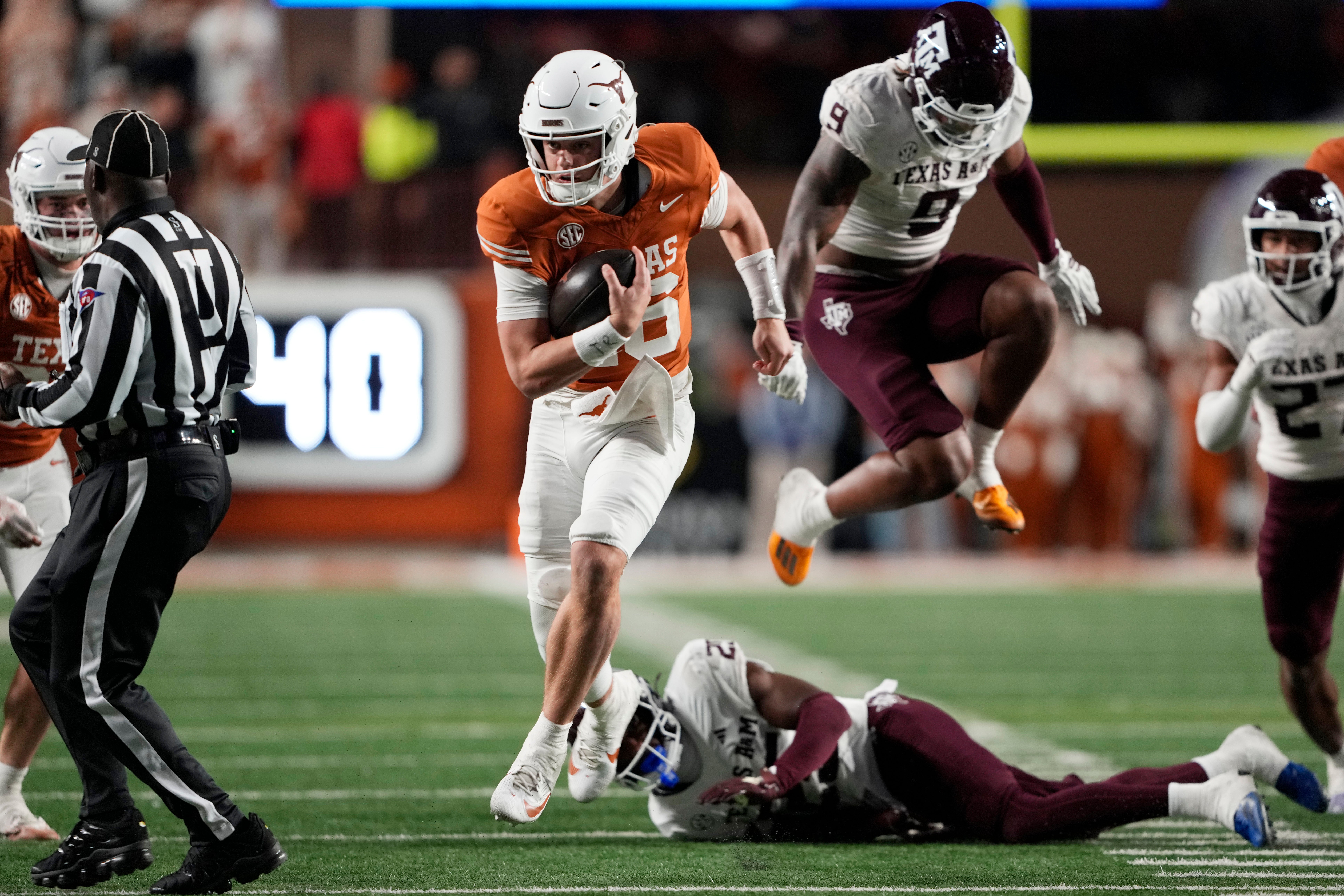 Nov 28, 2025; Austin, Texas, USA; Texas Longhorns quarterback Arch Manning keeps the ball and runs for a touchdown during the second half against the Texas A&M Aggies at Darrell K Royal-Texas Memorial Stadium. Mandatory Credit: Scott Wachter-Imagn Images