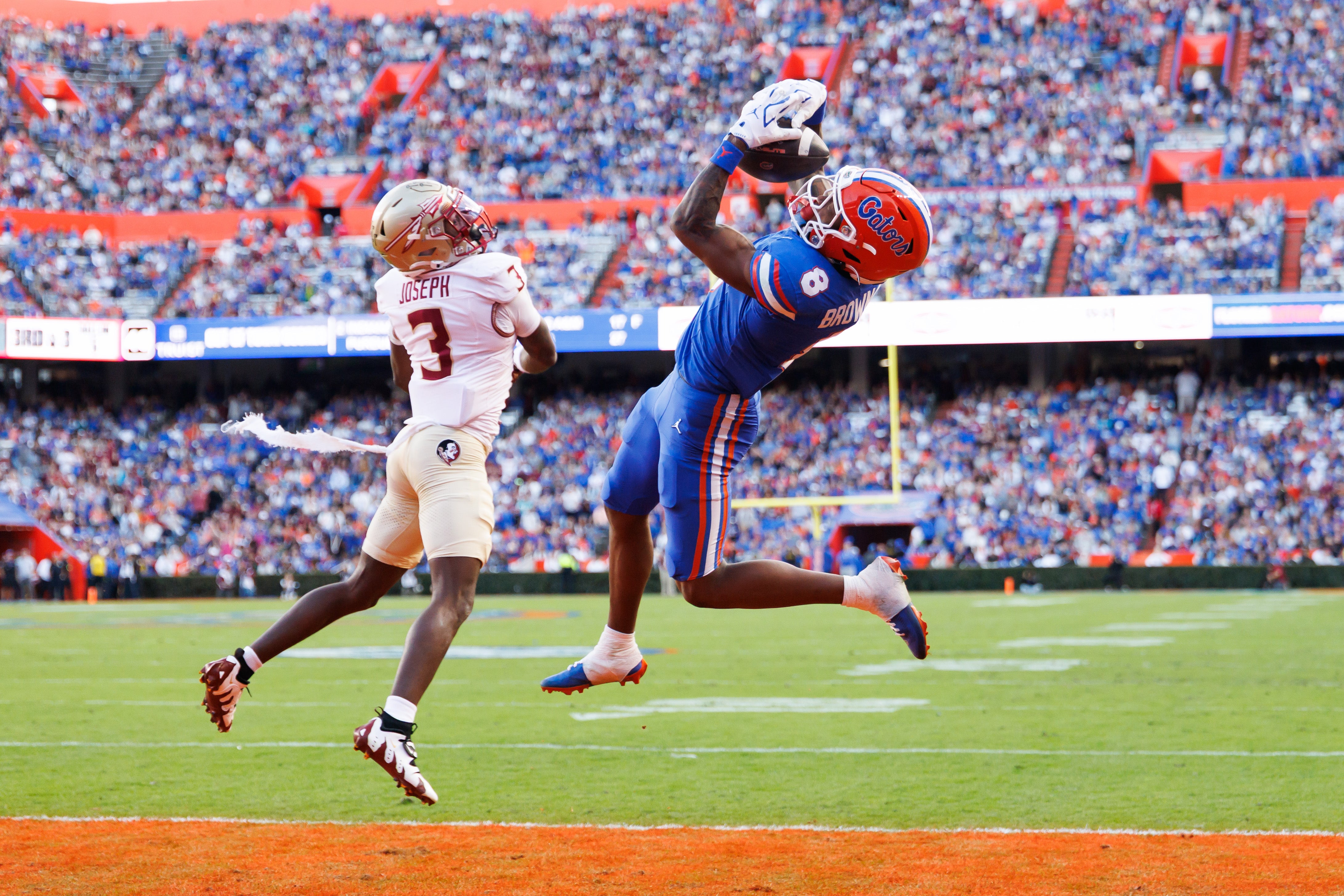 Nov 29, 2025; Gainesville, Florida, USA; Florida Gators wide receiver Vernell Brown III (8) attempts to make a catch over Florida State Seminoles defensive back Edwin Joseph (3) during the first half at Ben Hill Griffin Stadium.