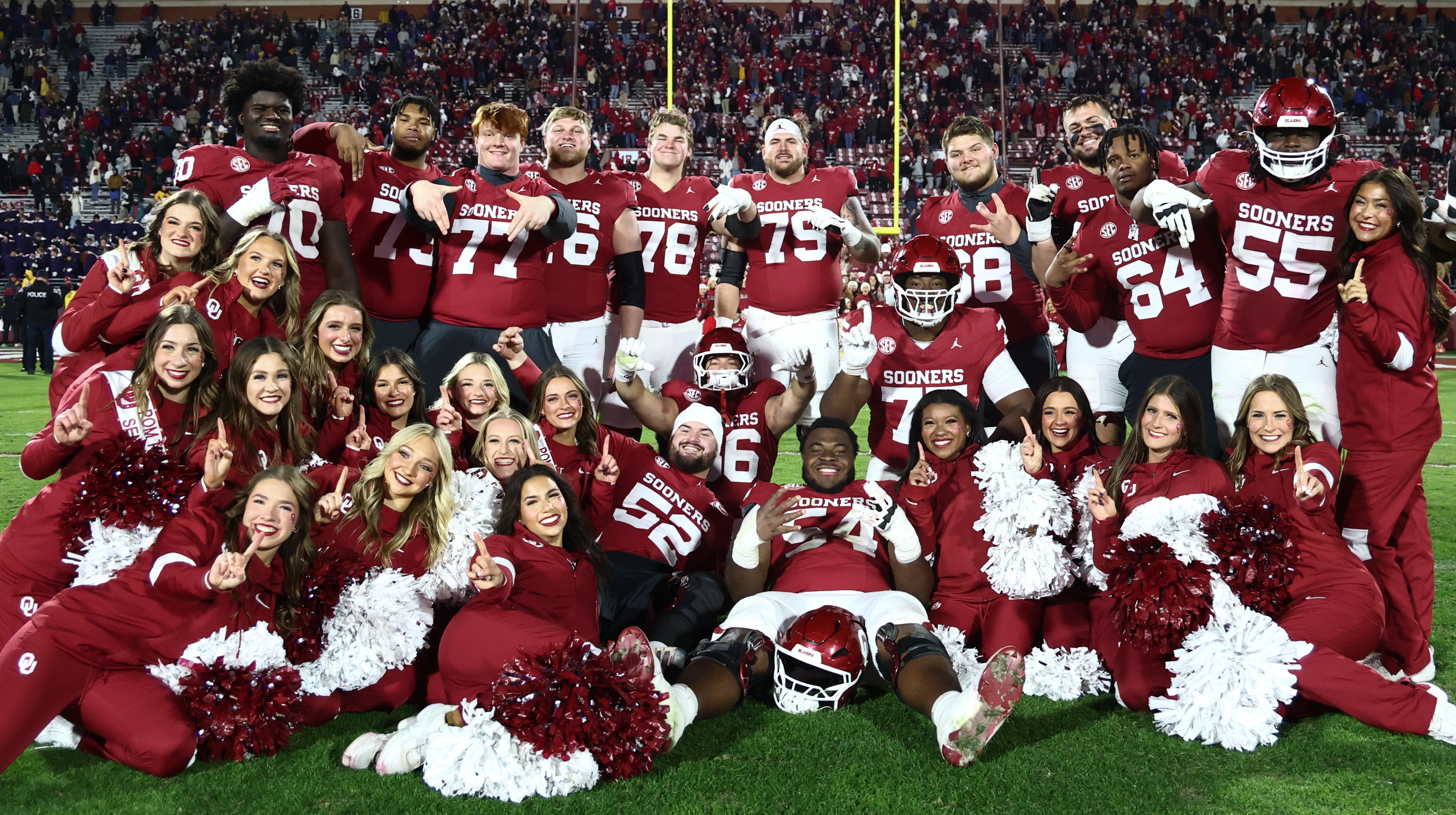 Nov 29, 2025; Norman, Oklahoma, USA; Oklahoma Sooners players take a photo with cheerleaders after the game against the Louisiana State Tigers at Gaylord Family-Oklahoma Memorial Stadium.