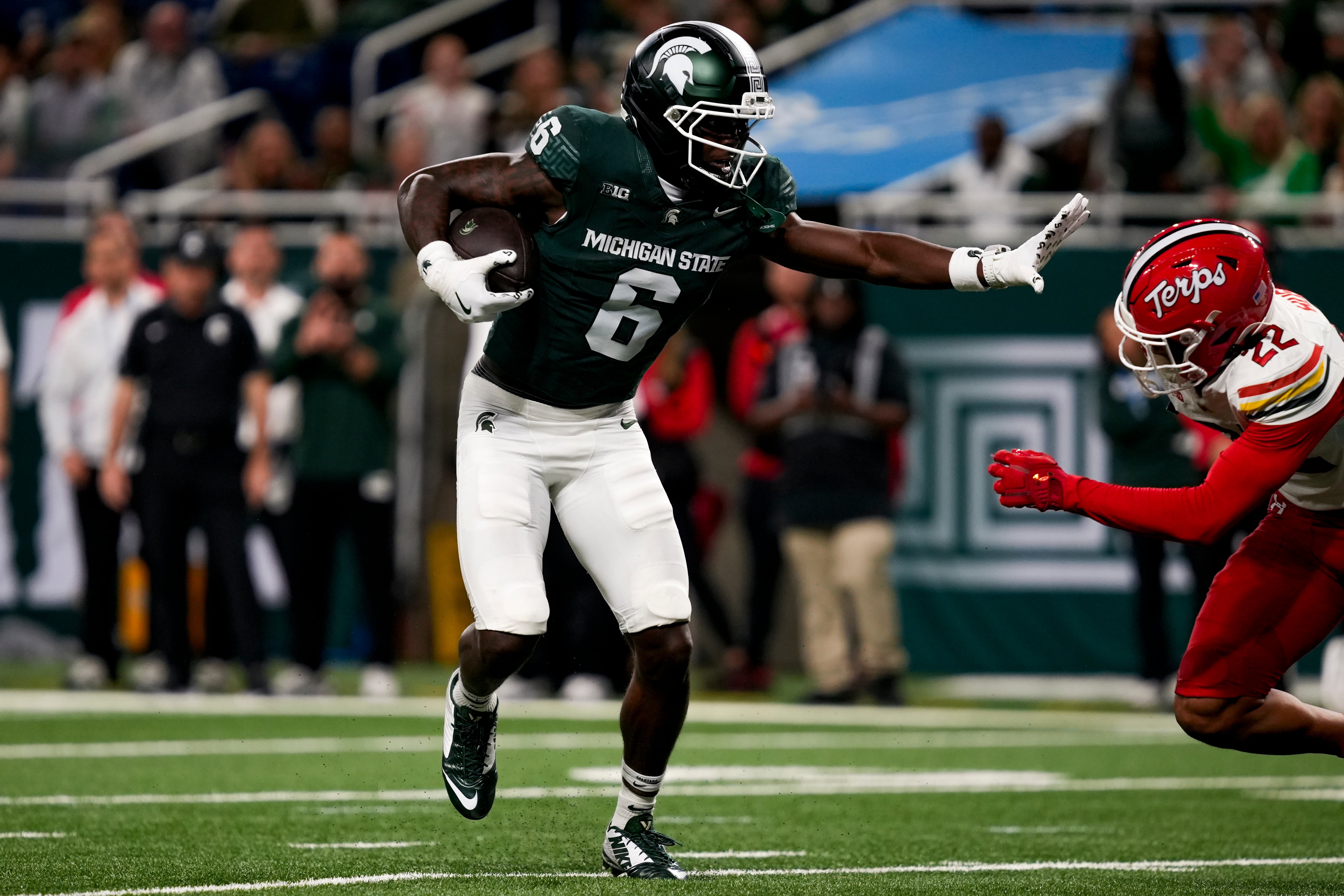 Nov 29, 2025; Detroit, Michigan, USA; Michigan State wide receiver Nick Marsh (6) stiff arms Maryland defensive back Jalen Huskey (22) in the second quarter at Ford Field. Mandatory Credit: Brendan Mullin-Imagn Images