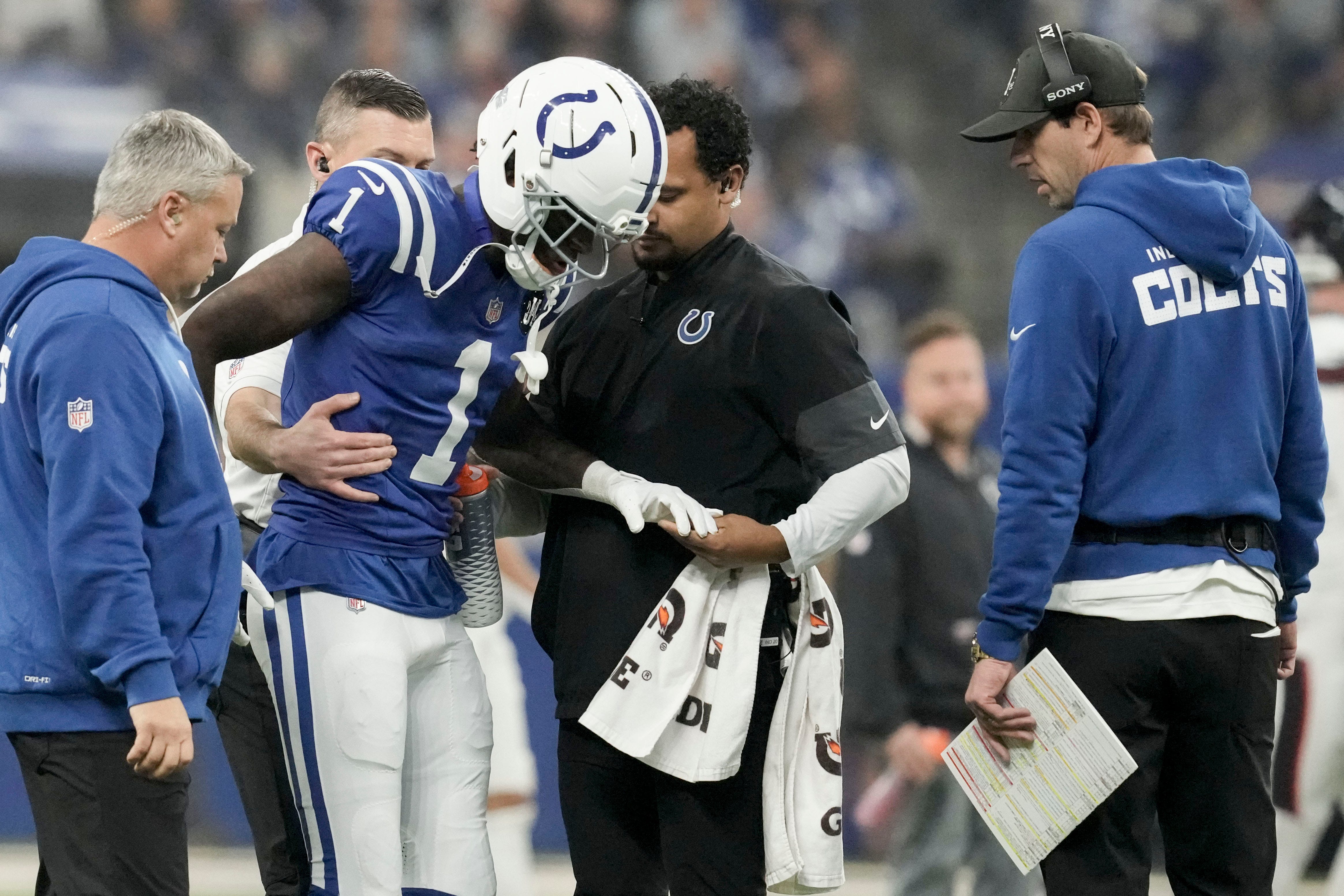 Colts CB Sauce Gardner being helped by trainers after an injury