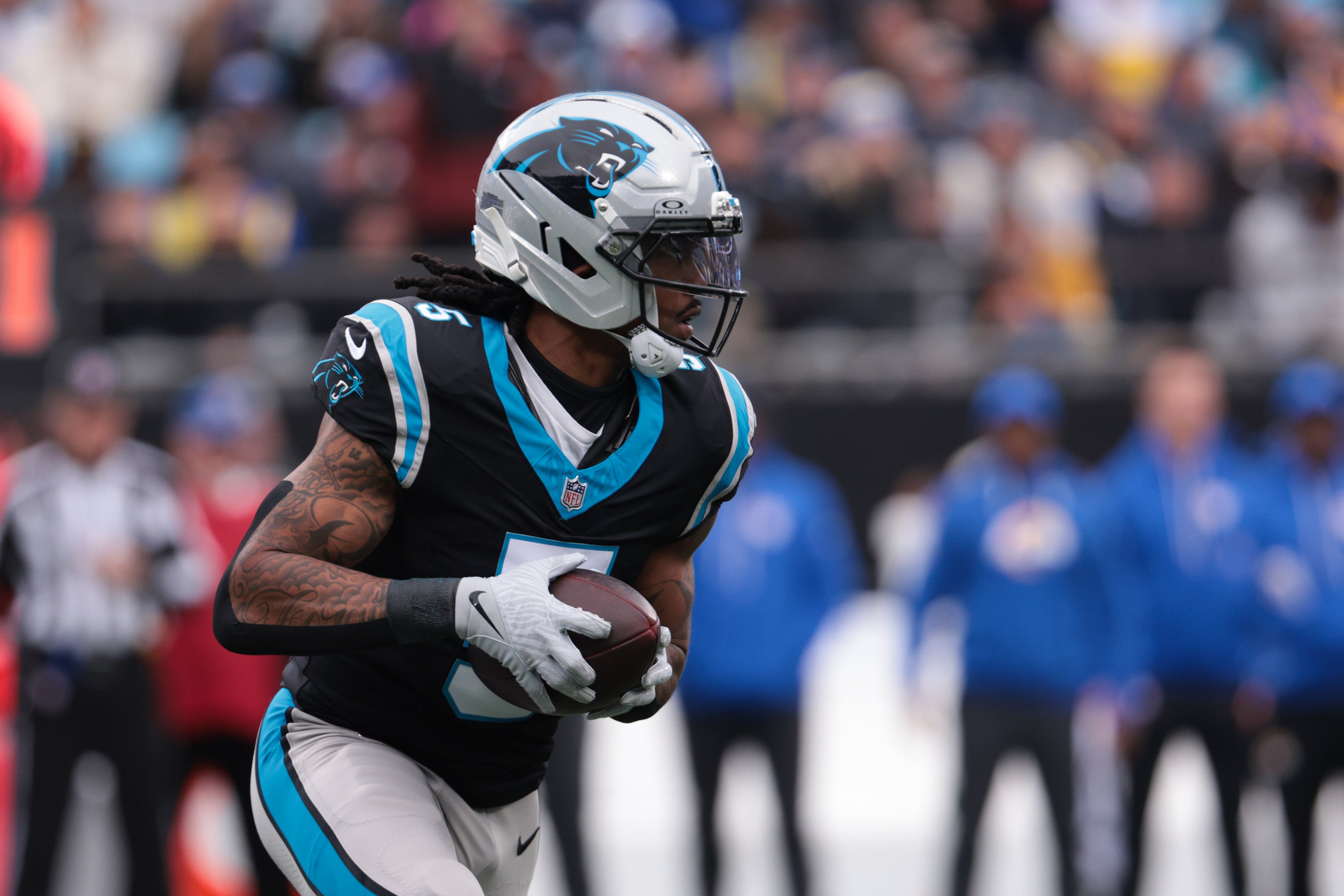 Nov 30, 2025; Charlotte, North Carolina, USA; Carolina Panthers running back Rico Dowdle (5) rushes during the first quarter against the Los Angeles Rams at Bank of America Stadium.