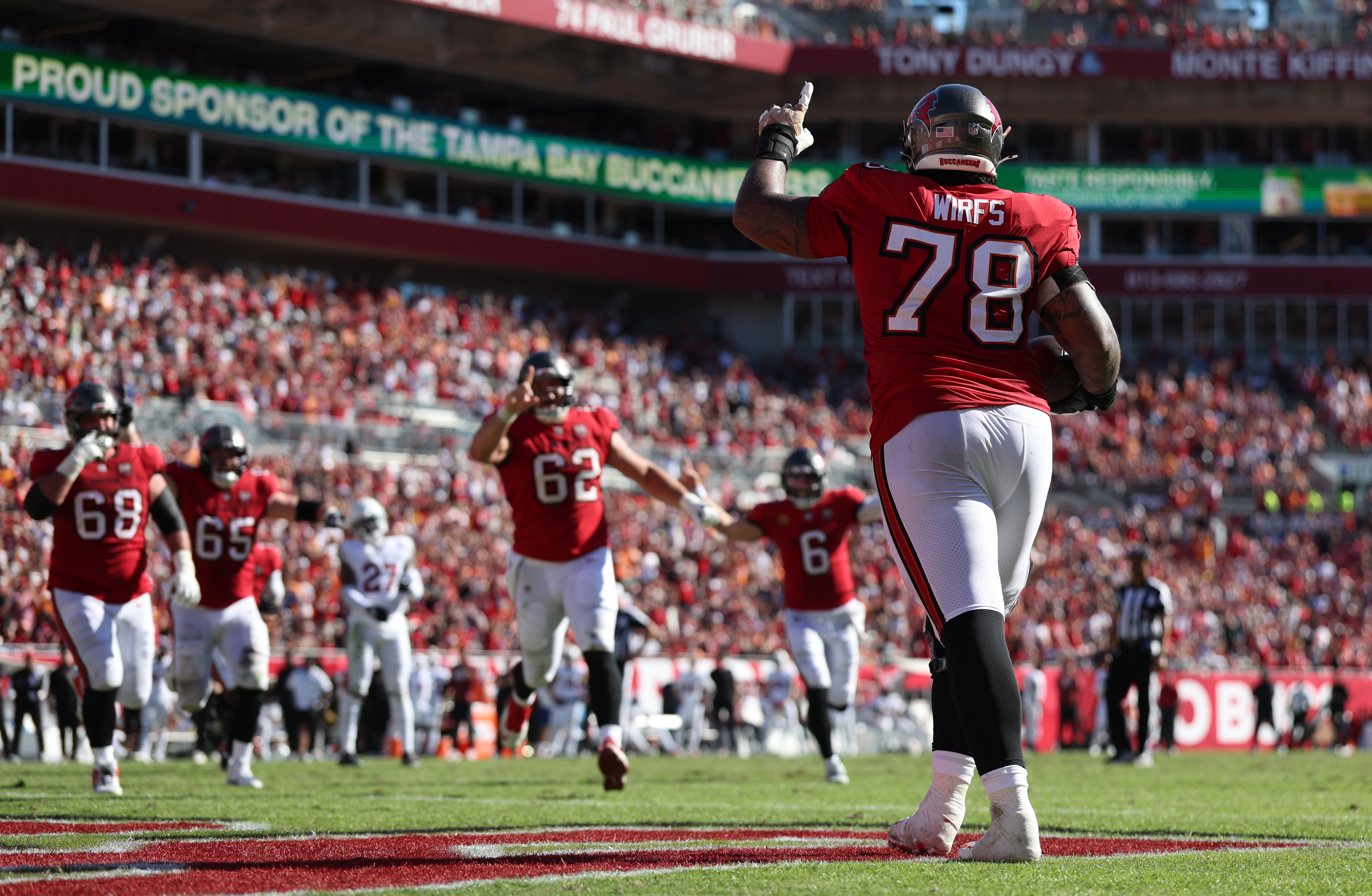 Nov 30, 2025; Tampa, Florida, USA; Tampa Bay Buccaneers offensive tackle Tristan Wirfs (78) celebrates with teammates after scoring a touchdown during the first half against the Arizona Cardinals at Raymond James Stadium.
