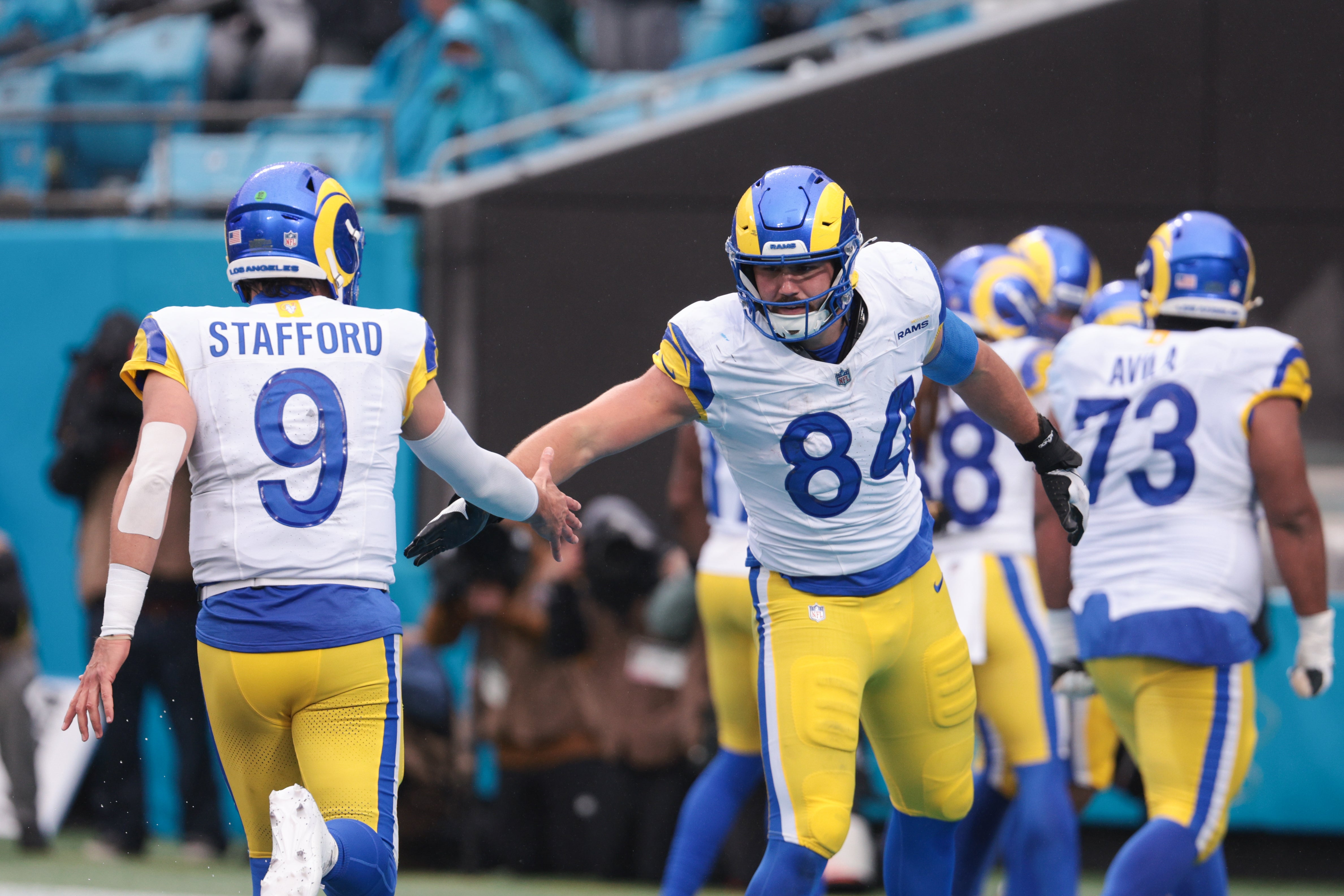 Nov 30, 2025; Charlotte, North Carolina, USA; Los Angeles Rams tight end Colby Parkinson (84) celebrates with Los Angeles Rams quarterback Matthew Stafford (9) during the fourth quarter against the Carolina Panthers at Bank of America Stadium.