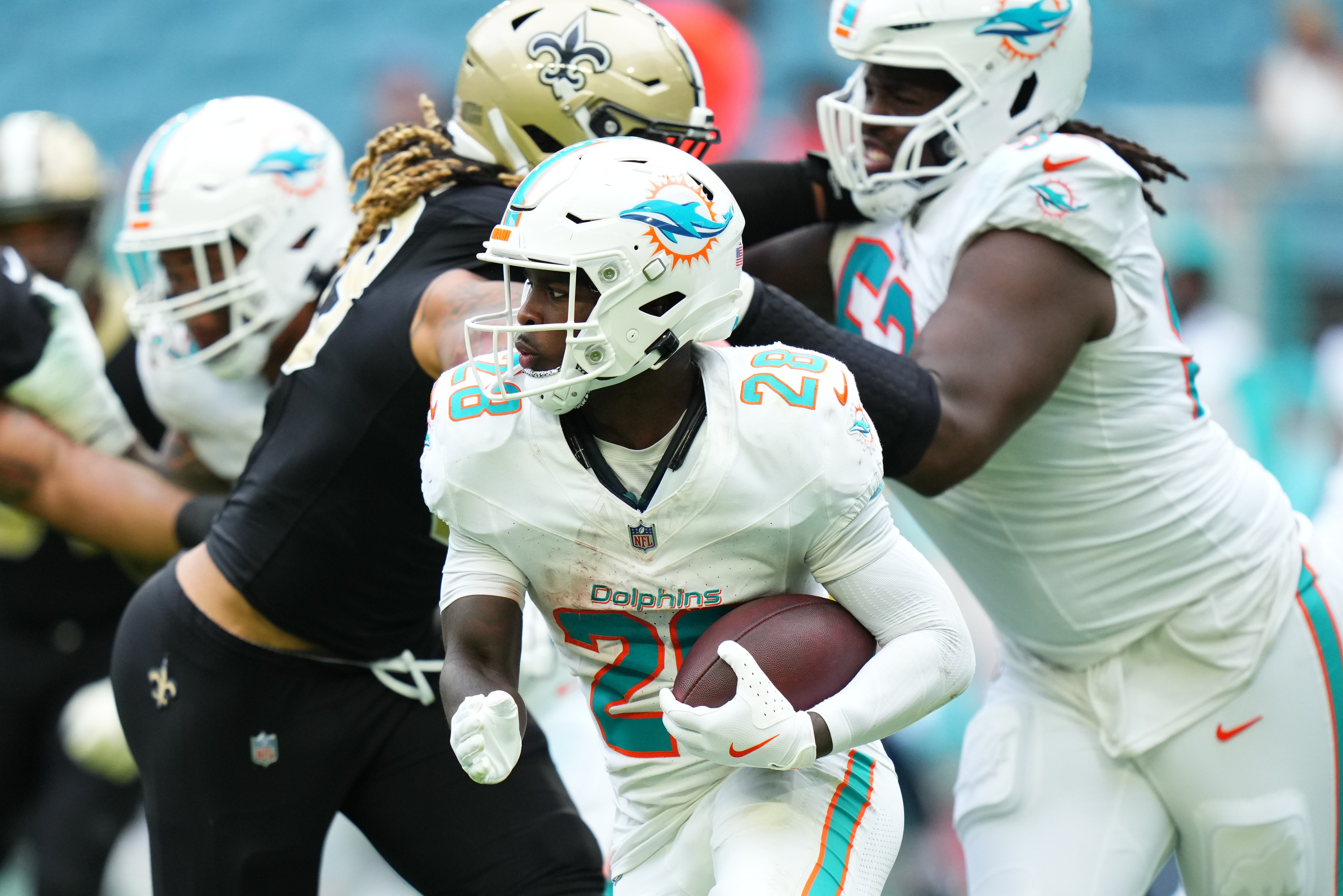 Nov 30, 2025; Miami Gardens, Florida, USA; Miami Dolphins running back De'Von Achane (28) carries the ball against the New Orleans Saints during the second half at Hard Rock Stadium.
