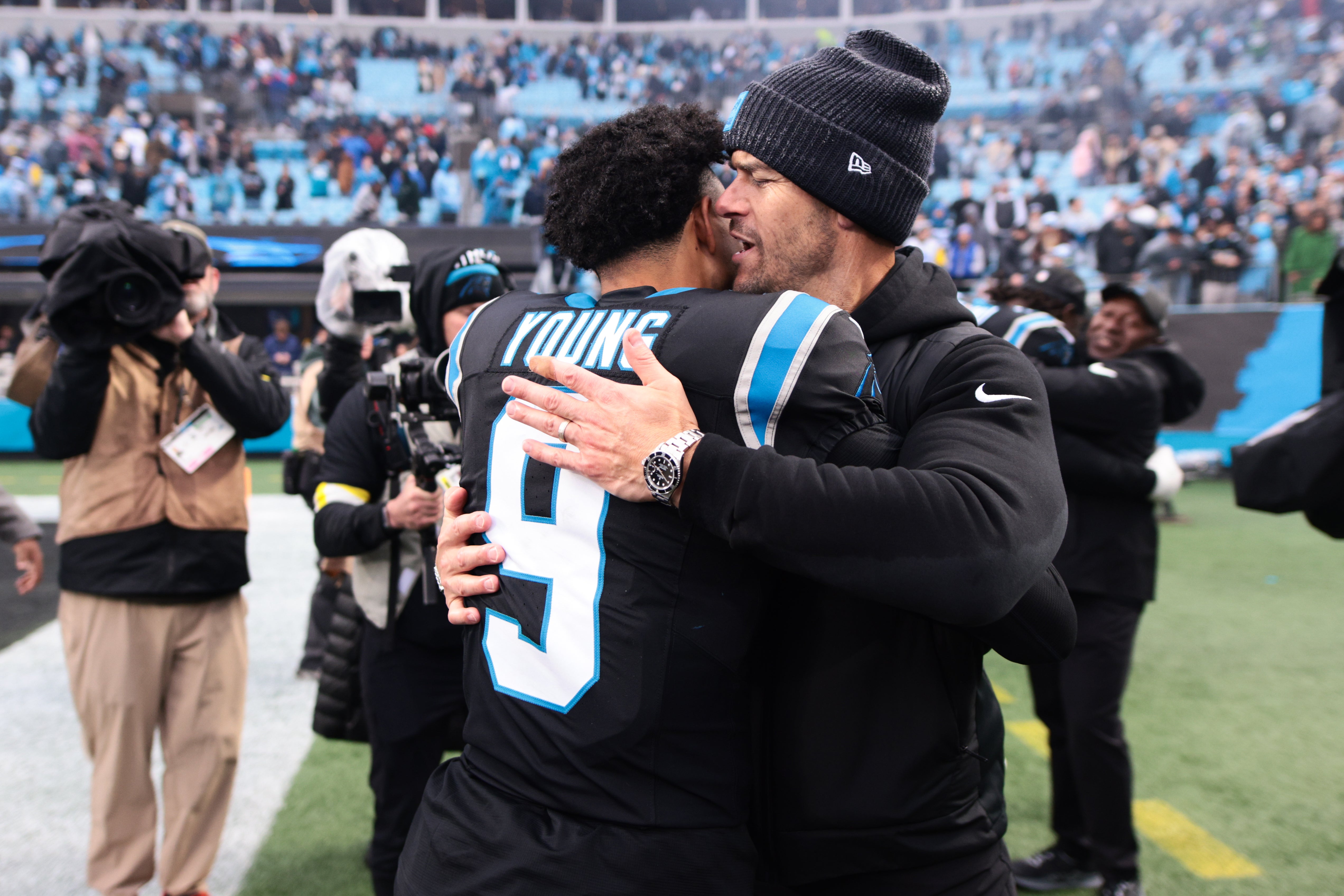 Nov 30, 2025; Charlotte, North Carolina, USA; Carolina Panthers head coach Dave Canales celebrates with Carolina Panthers quarterback Bryce Young (9) after the game against the Los Angeles Rams at Bank of America Stadium.