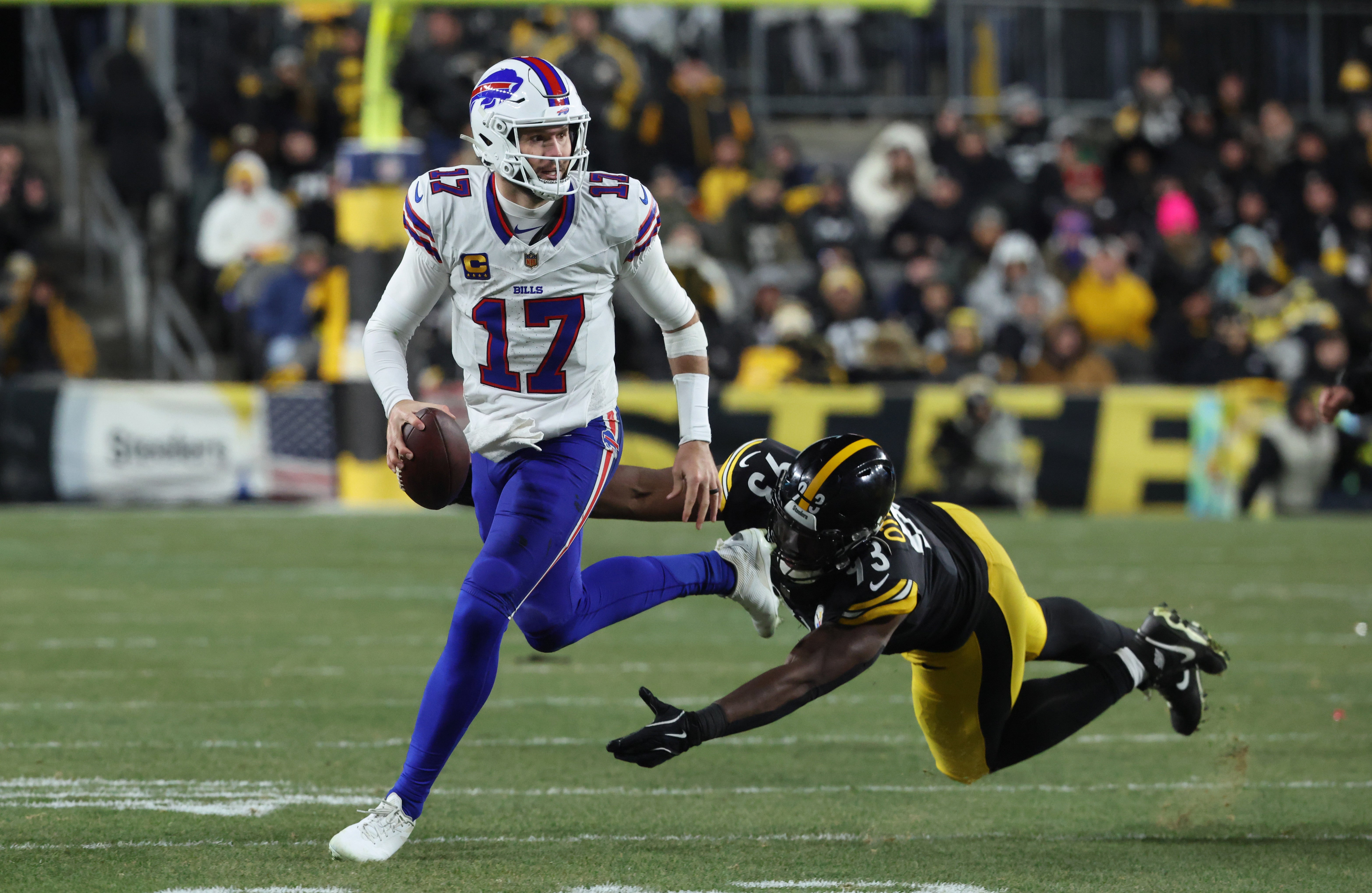 Nov 30, 2025; Pittsburgh, Pennsylvania, USA; Buffalo Bills quarterback Josh Allen (17) looks to pass as Pittsburgh Steelers defensive end Esezi Otomewo (93) attempts to tackle during the second quarter at Acrisure Stadium.