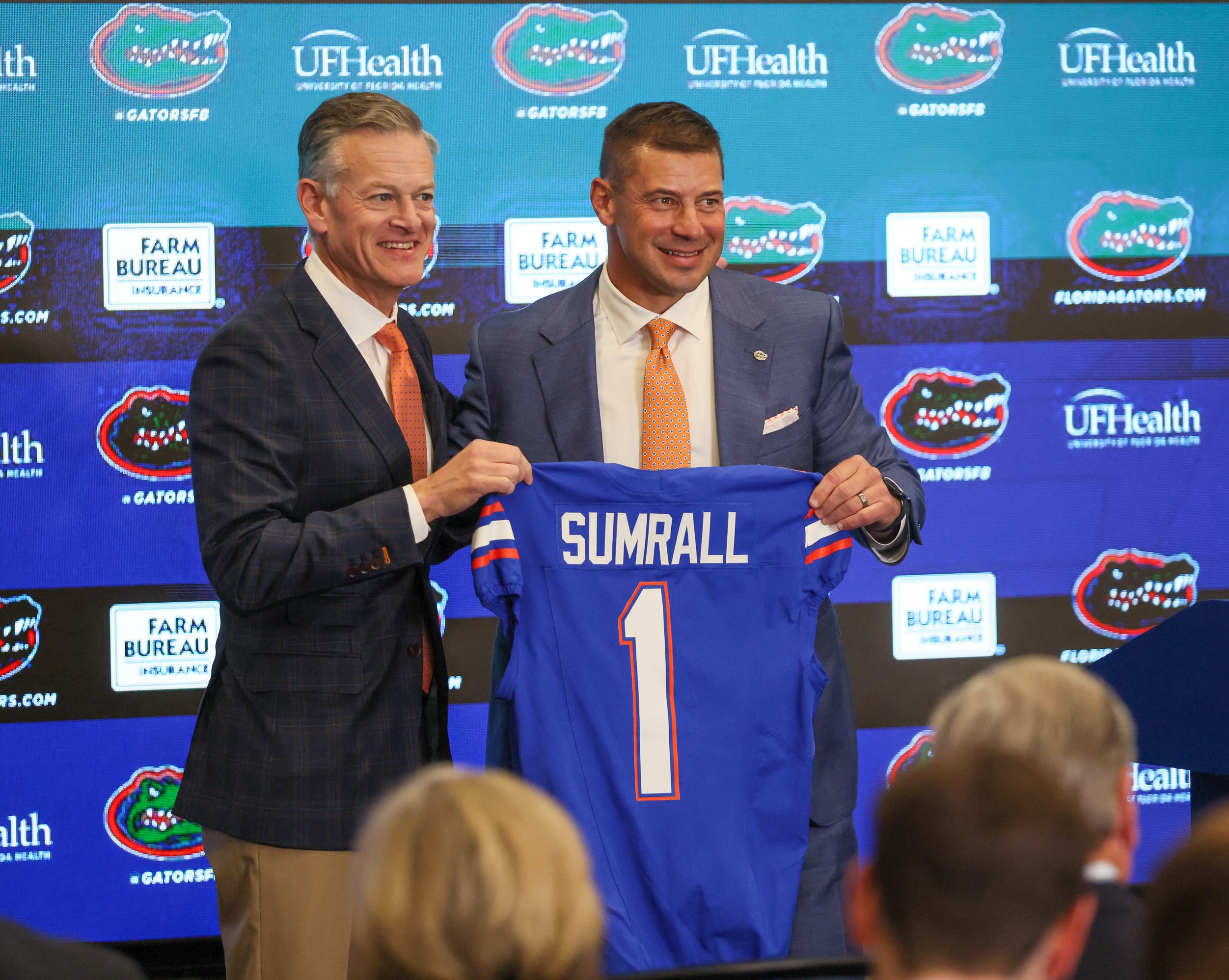 UF Athletic Director Scott Stricklin and new UF head football coach Jon Sumrall pose with a jersey at a press conference James W. “Bill” Heavener Football Training Center in Gainesville, FL on Monday, December 1, 2025.