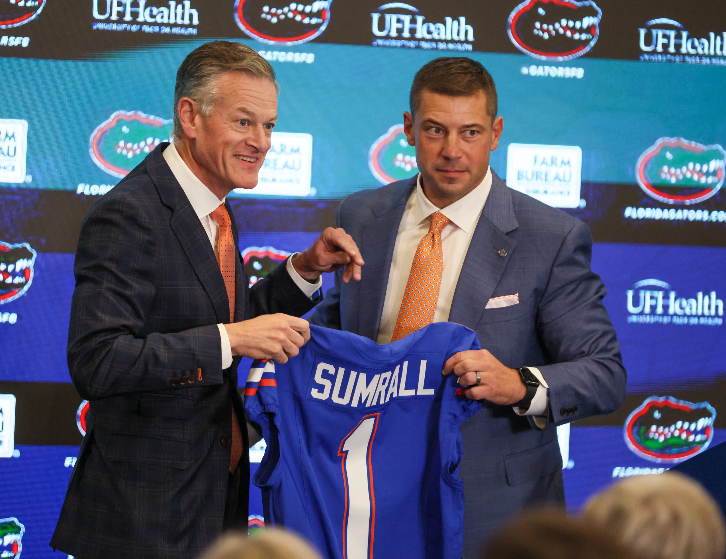 UF Athletic Director Scott Stricklin and new UF head football coach Jon Sumrall pose with a jersey at a press conference James W. “Bill” Heavener Football Training Center in Gainesville, FL on Monday, December 1, 2025.