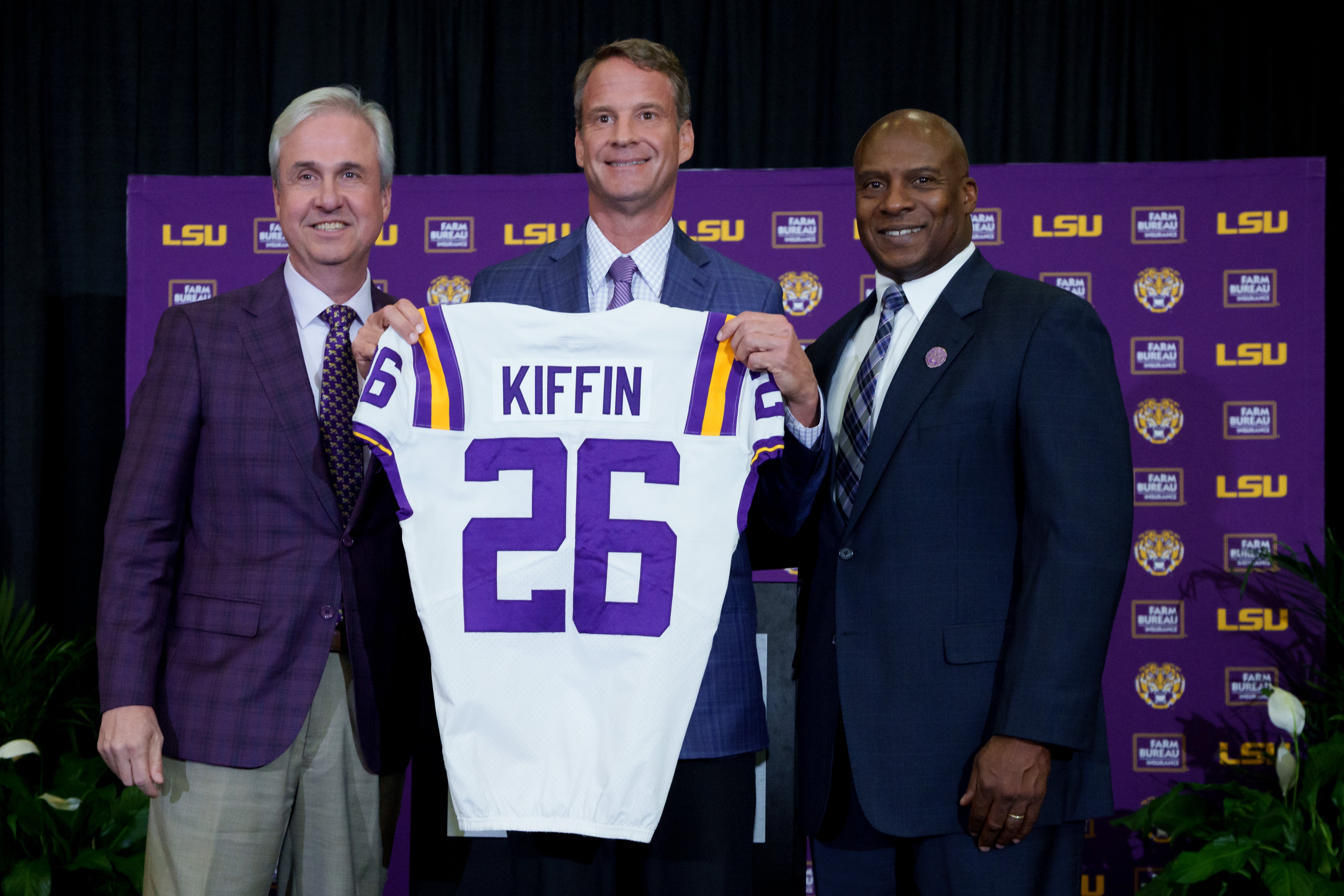 Dec 1, 2025; Baton Rouge, LA, USA; LSU president Wade Rousse, left, LSU new head coach Lane Kiffin and LSU athletic director Verge Ausberry stand together at South Stadium Club at Tiger Stadium. Mandatory Credit: Matthew Hinton-Imagn Images