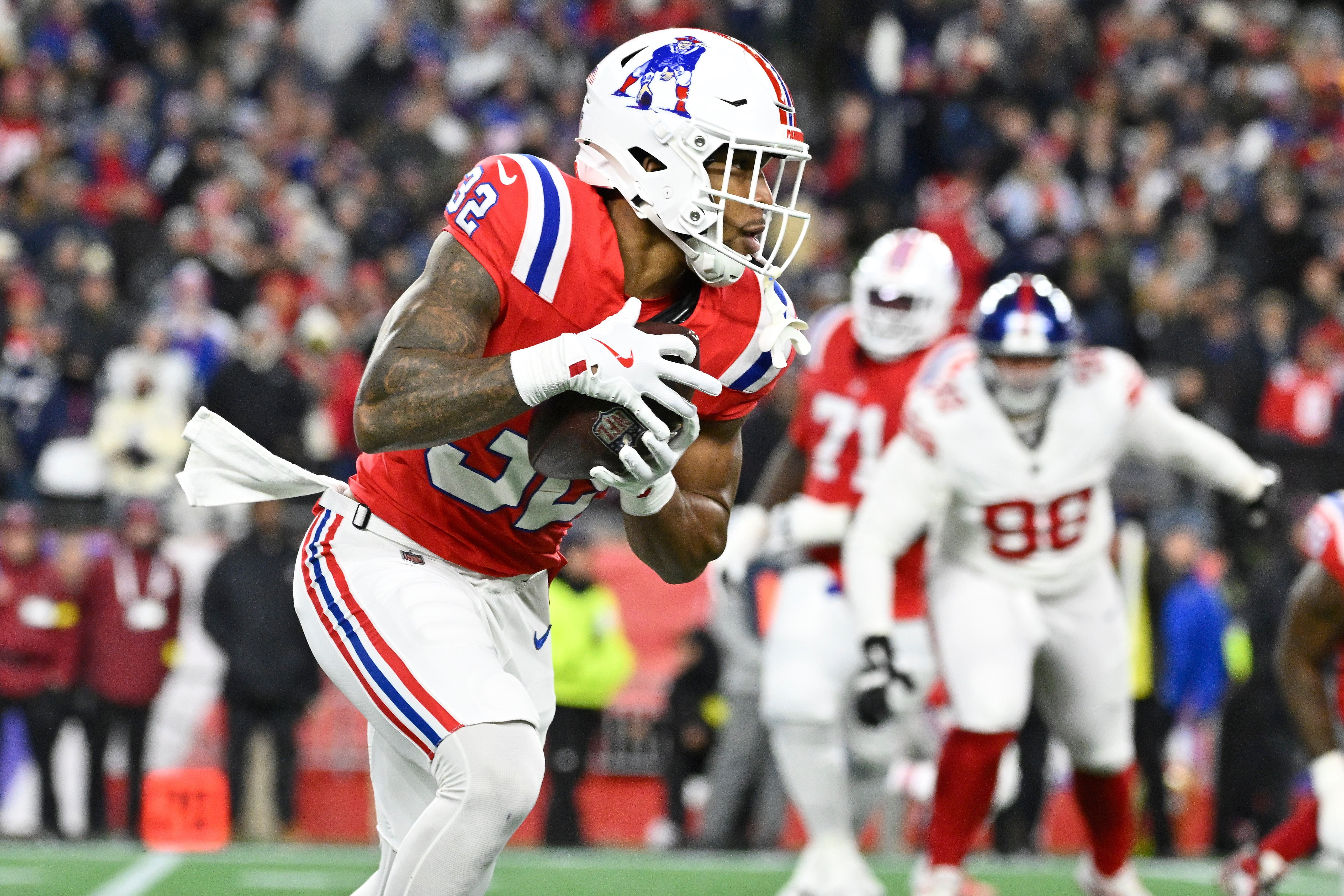 Dec 1, 2025; Foxborough, Massachusetts, USA; New England Patriots running back TreVeyon Henderson (32) runs the ball during the second quarter against the New York Giants at Gillette Stadium.