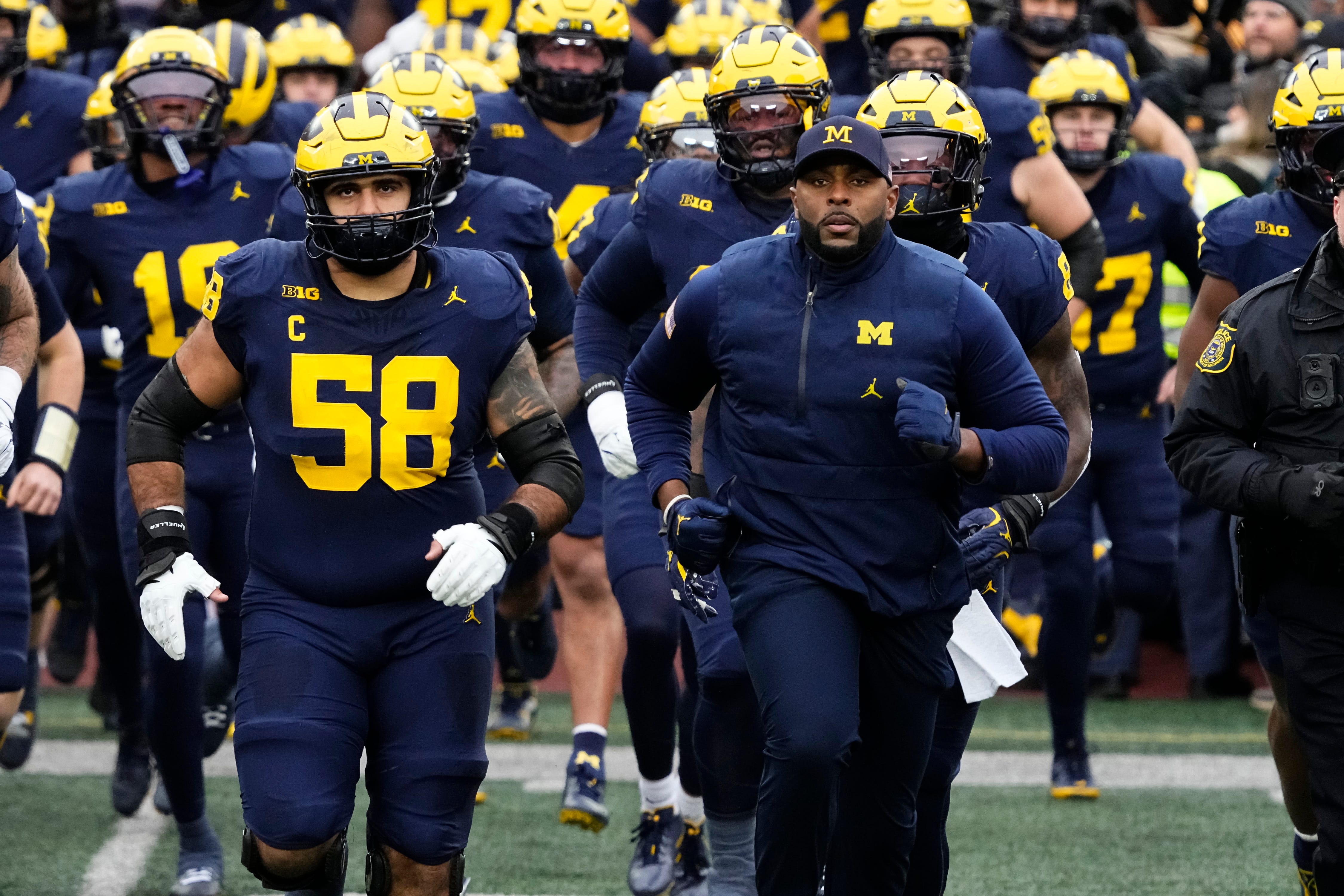 Michigan Wolverines head coach Sherrone Moore leads his team onto the field for the NCAA football game against the Ohio State Buckeyes at Michigan Stadium in Ann Arbor, Mich. on Nov. 29, 2025. Ohio State won 27-9.