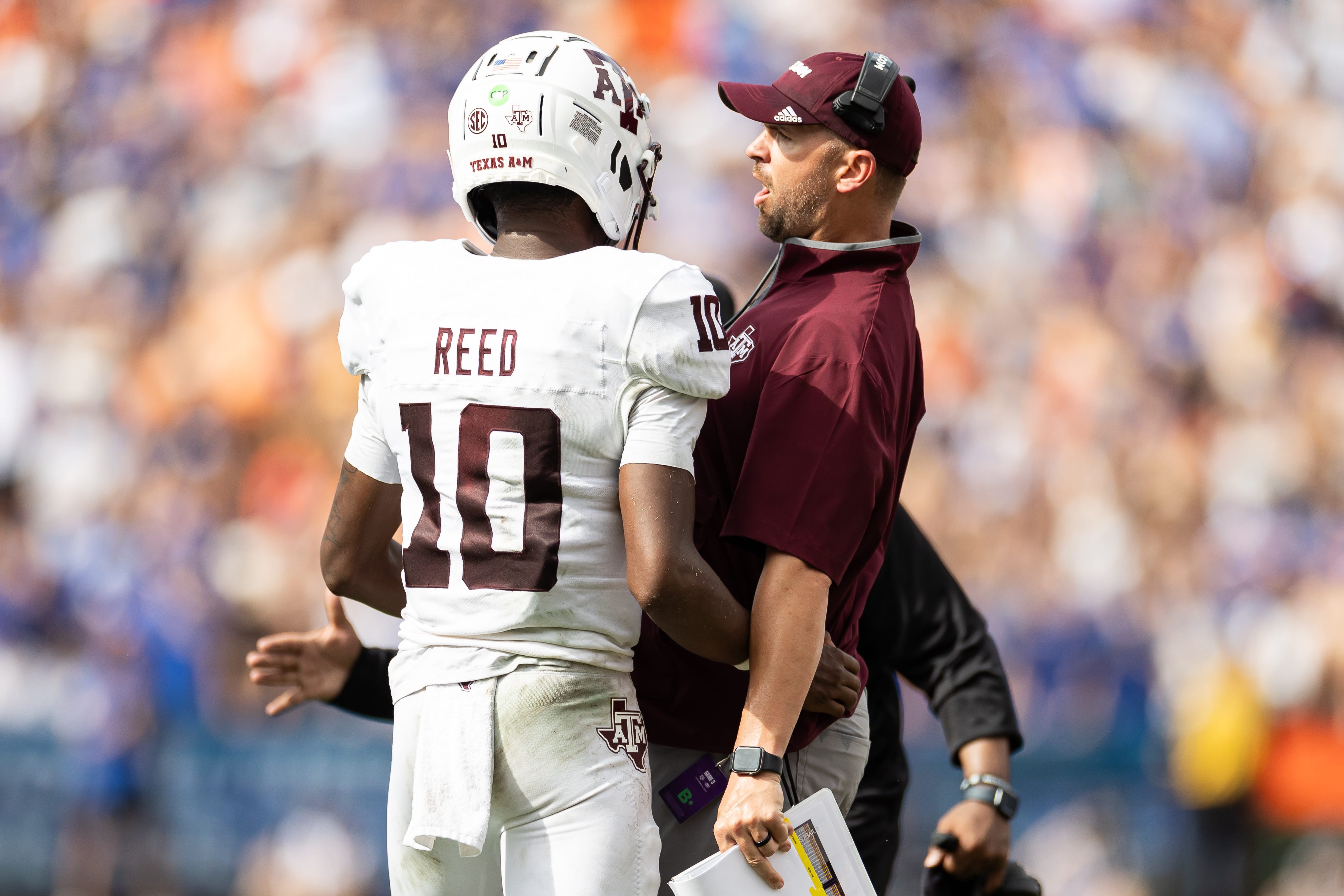 Sep 14, 2024; Gainesville, Florida, USA; Texas A&M Aggies quarterback Marcel Reed (10) celebrates with Texas A&M Aggies offensive coordinator Collin Klein after a touchdown against the Florida Gators during the first half at Ben Hill Griffin Stadium.