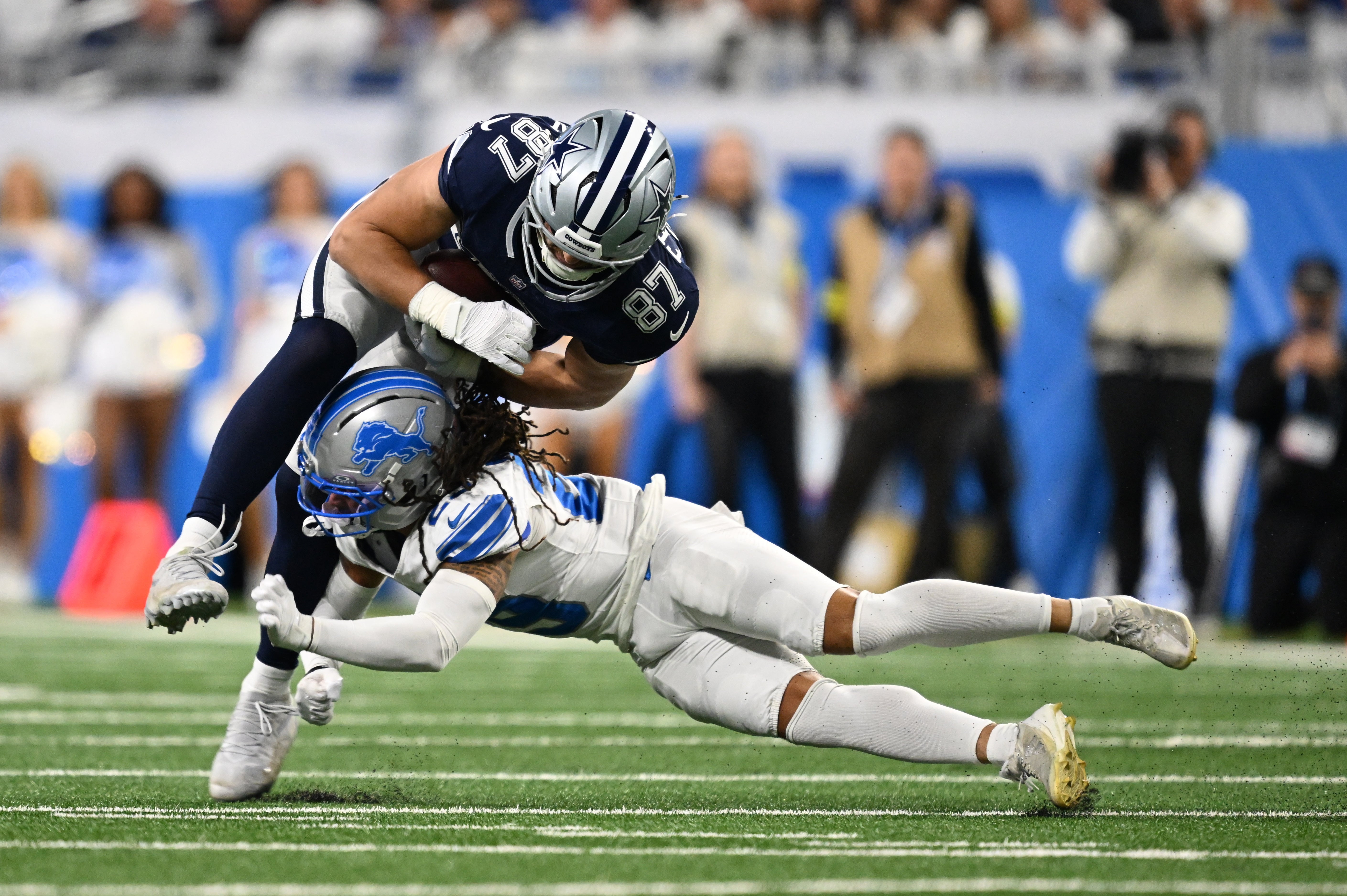 Dec 4, 2025; Detroit, Michigan, USA; Detroit Lions cornerback Avonte Maddox (29) tackles Dallas Cowboys tight end Jake Ferguson (87) during the first half at Ford Field.