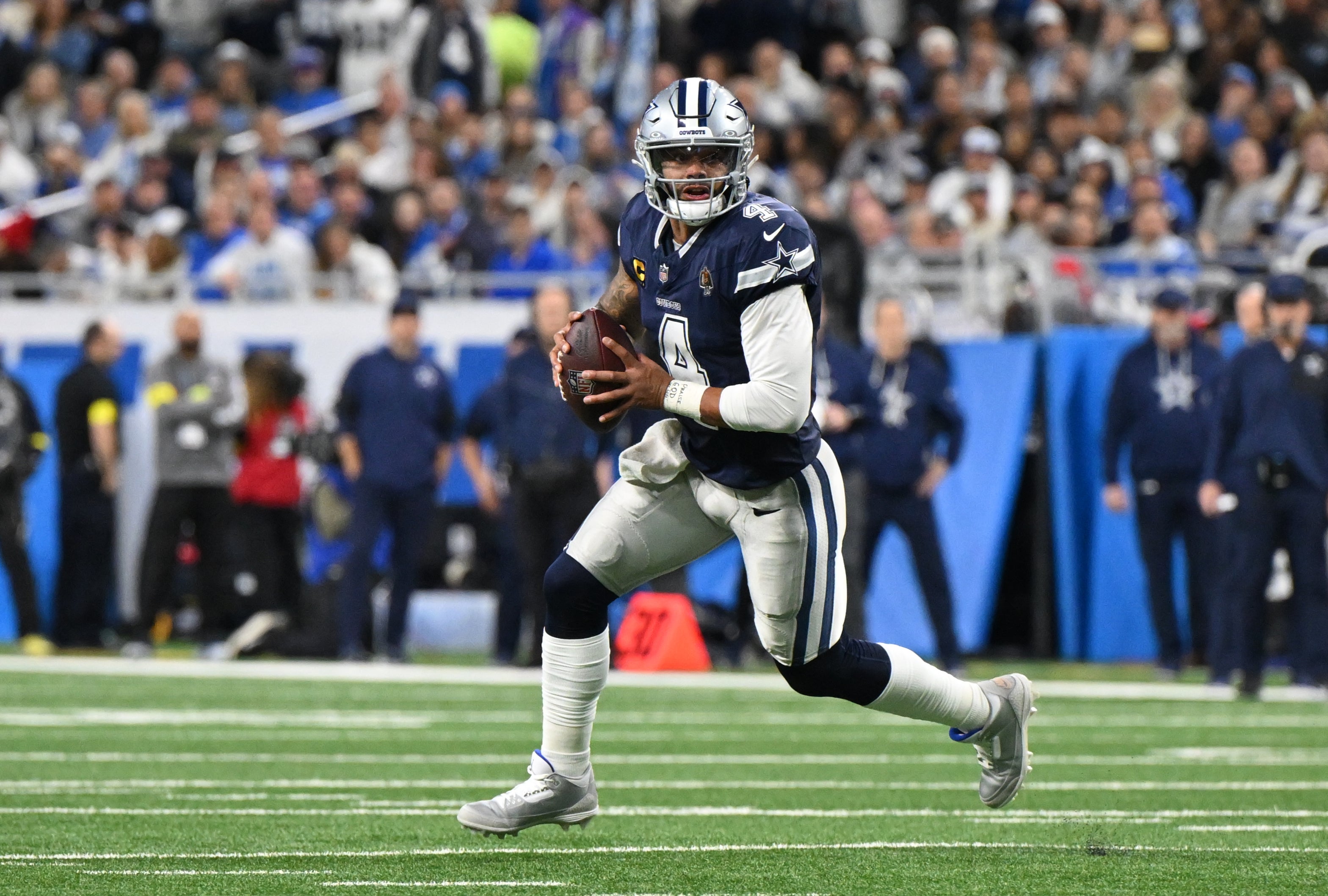 Dec 4, 2025; Detroit, Michigan, USA; Dallas Cowboys quarterback Dak Prescott (4) scrambles during the first half against the Detroit Lions at Ford Field.