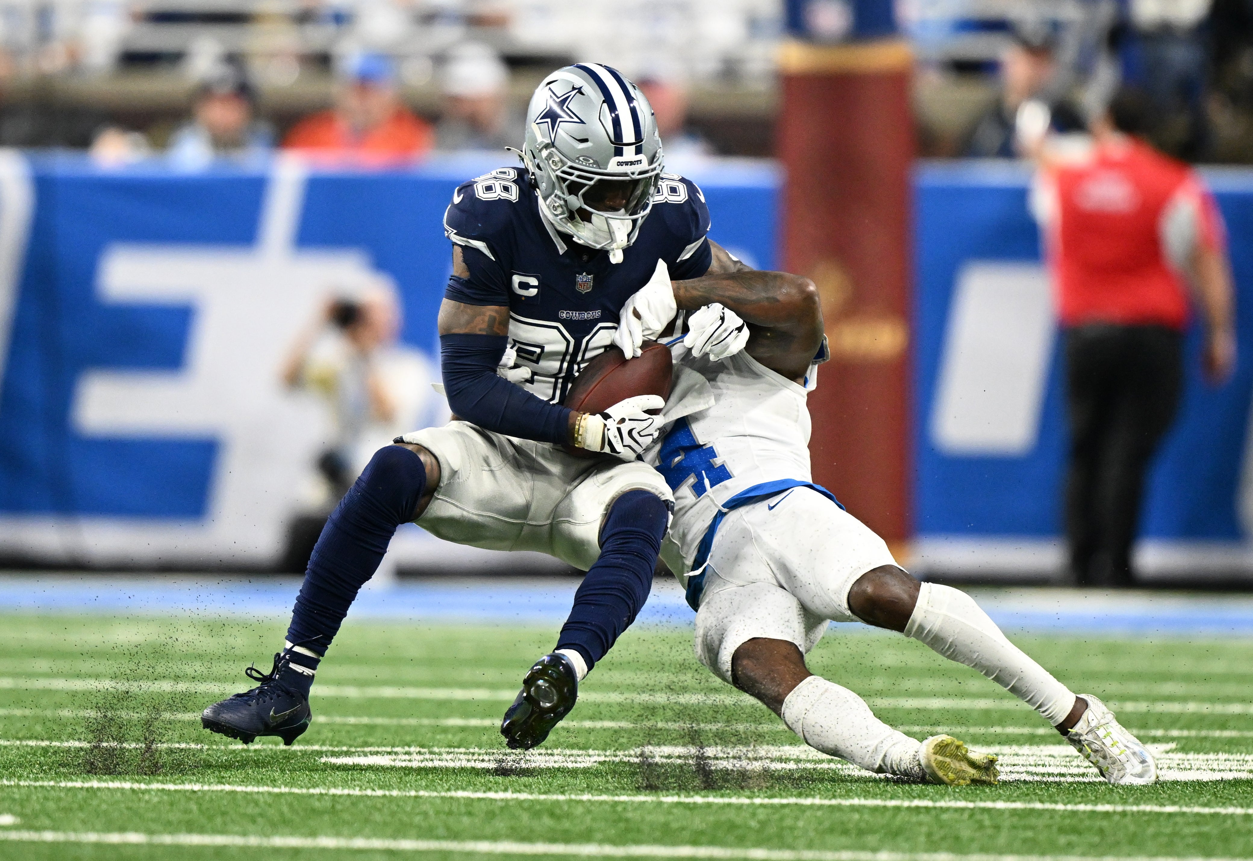 Dec 4, 2025; Detroit, Michigan, USA; Dallas Cowboys wide receiver CeeDee Lamb (88) makes a catch against Detroit Lions cornerback D.J. Reed (4) during the second half at Ford Field.