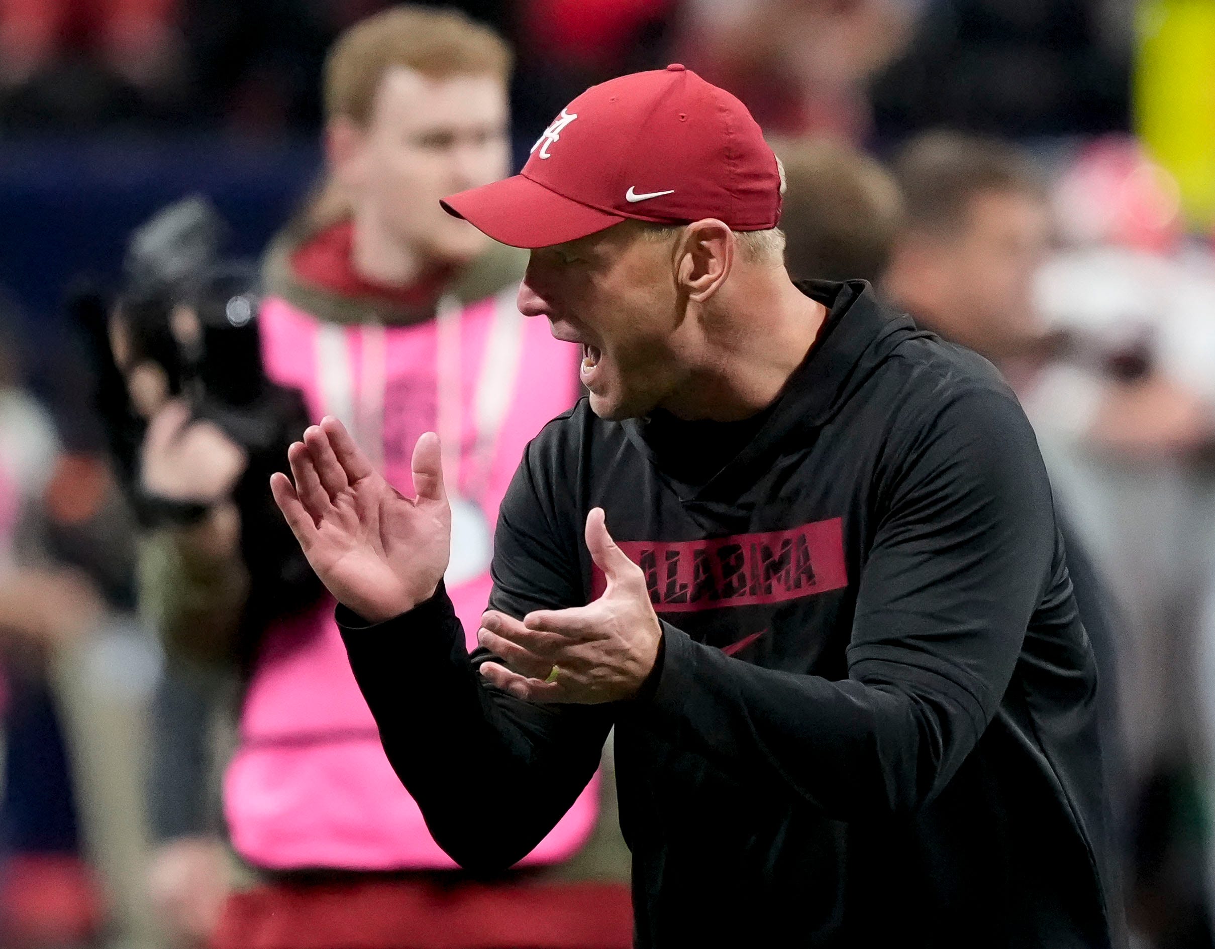 Dec 6, 2025; Atlanta, GA, USA; Alabama head coach Kalen DeBoer encourages his players as they warm up before the SEC Championship Game at Mercedes-Benz Stadium.