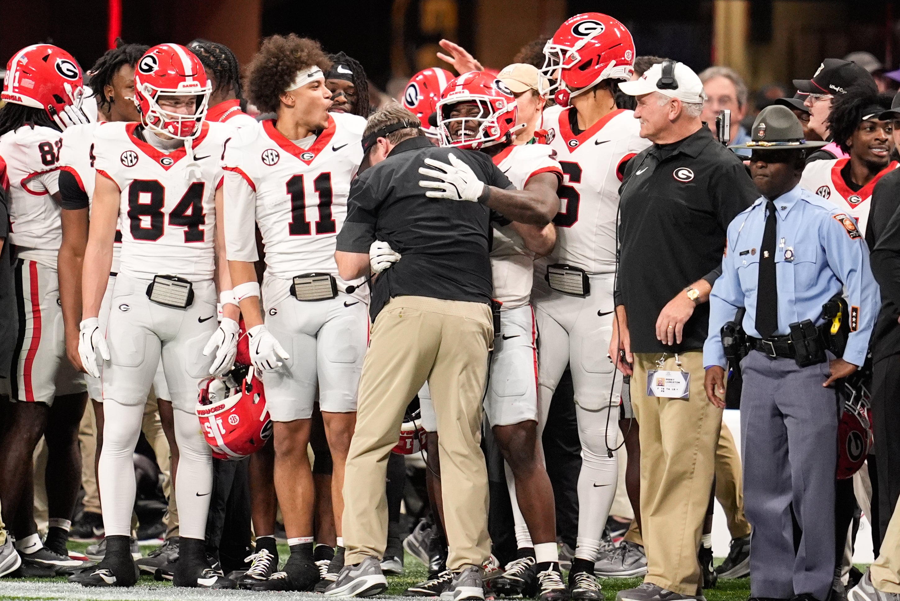 Dec 6, 2025; Atlanta, GA, USA; Georgia Bulldogs players celebrate with Georgia Bulldogs head coach Kirby Smart during the fourth quarter against the Alabama Crimson Tide during the 2025 SEC Championship game at Mercedes-Benz Stadium. Mandatory Credit: Dale Zanine-Imagn Images
