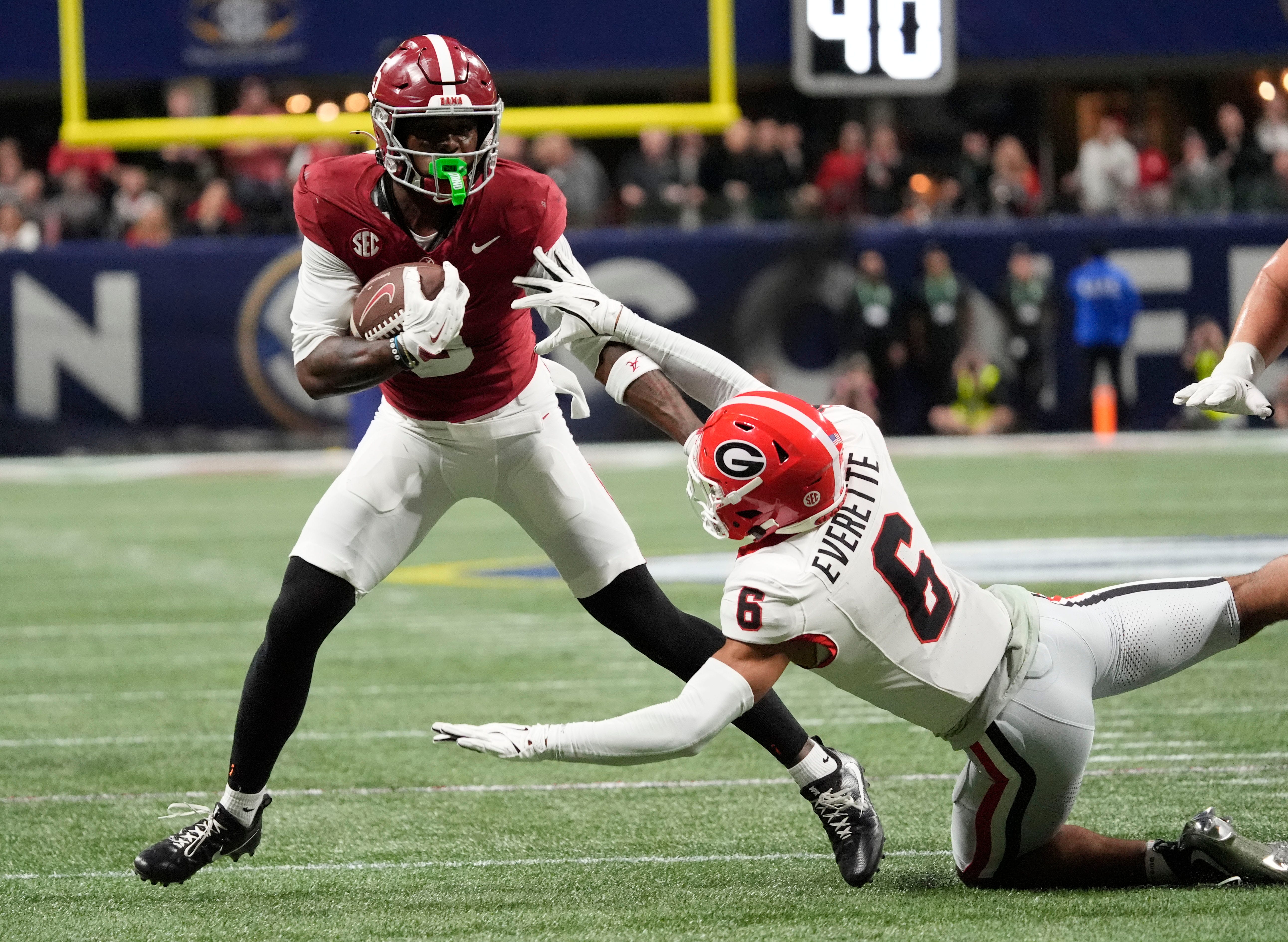 Dec 6, 2025; Atlanta, GA, USA; Alabama wide receiver Germie Bernard (5) evades a tackle by Georgia defensive back Daylen Everette (6) at Mercedes-Benz Stadium