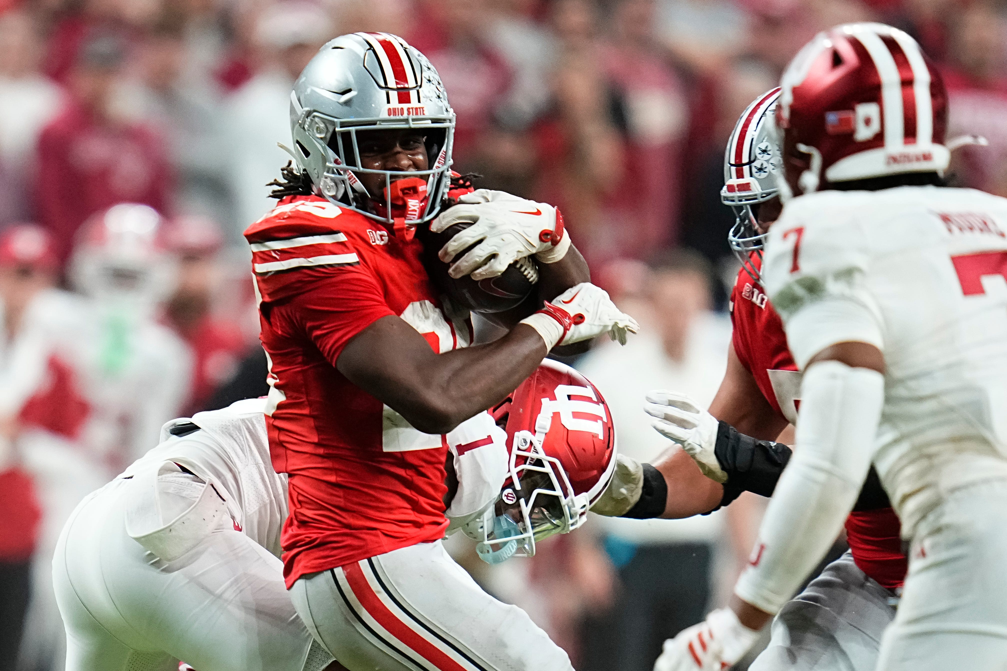 Ohio State Buckeyes running back Bo Jackson (25) spins arouns Indiana Hoosiers defensive back Amare Ferrell (1) during the Big Ten Conference championship game at Lucas Oil Stadium in Indianapolis on Dec. 6, 2025. Ohio State lost 13-10.