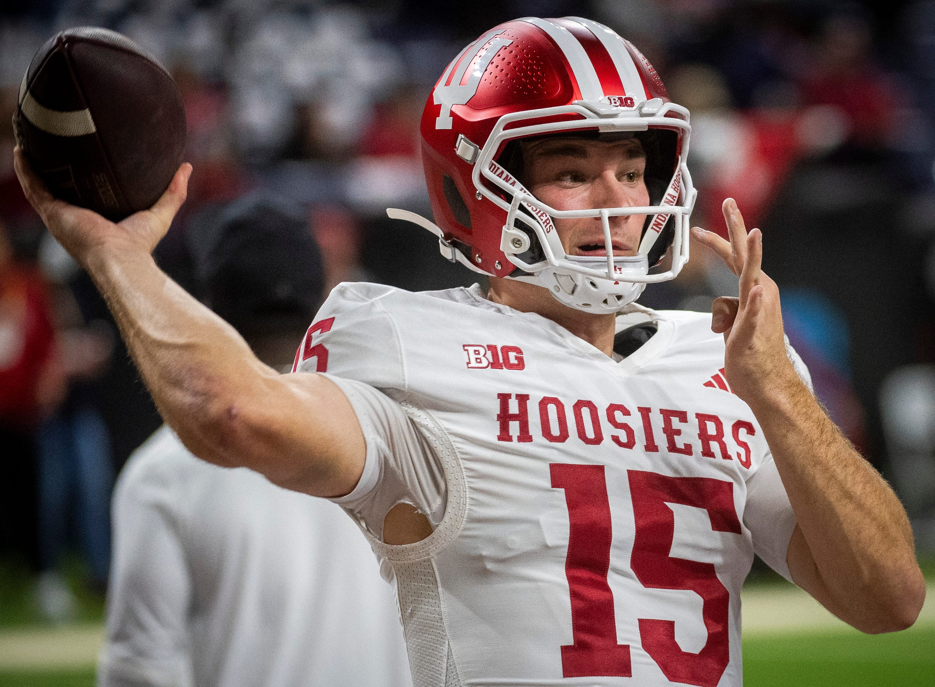 Indiana's Fernando Mendoza (15) gets loose before the Indiana versus Ohio State Big Ten Championship football game at Lucas Oil Stadium on Saturday, Dec. 6, 2025.