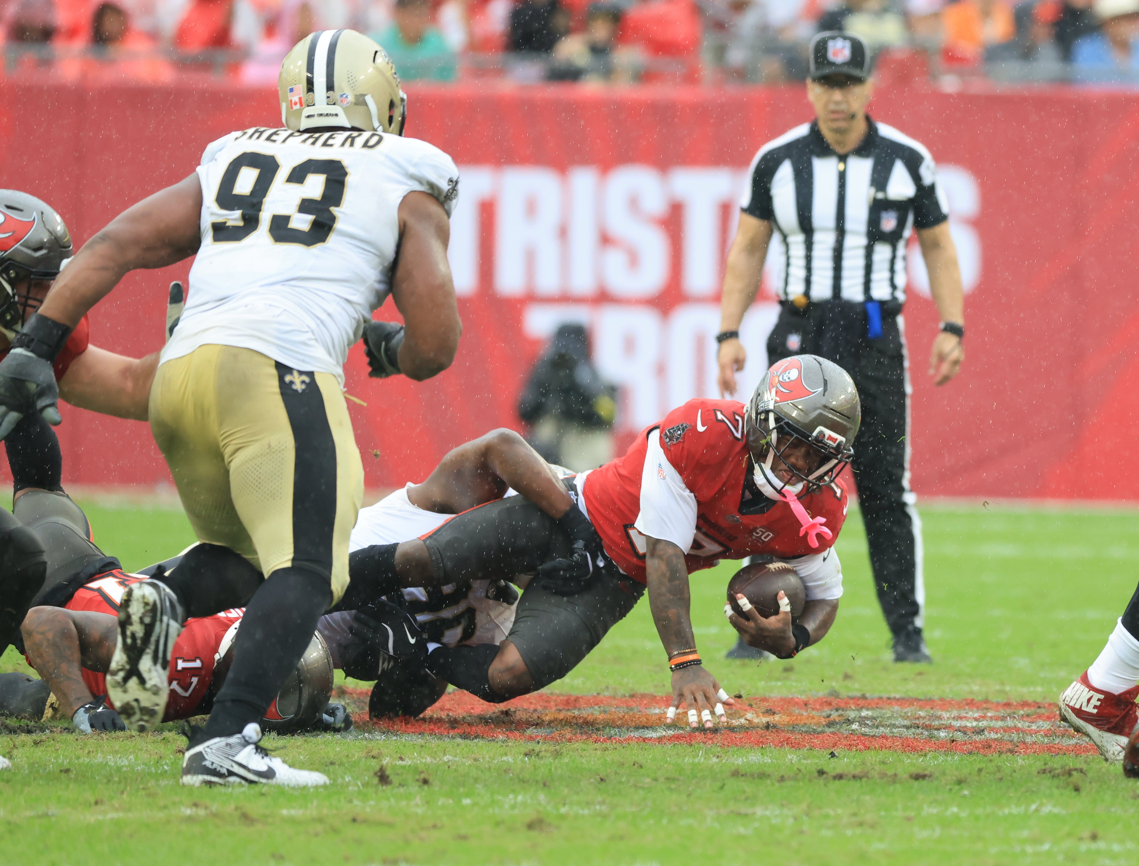 Dec 7, 2025; Tampa, Florida, USA; Tampa Bay Buccaneers running back Bucky Irving (7) is tackled by New Orleans Saints defensive tackle Bryan Bresee (90) during the second quarter at Raymond James Stadium.