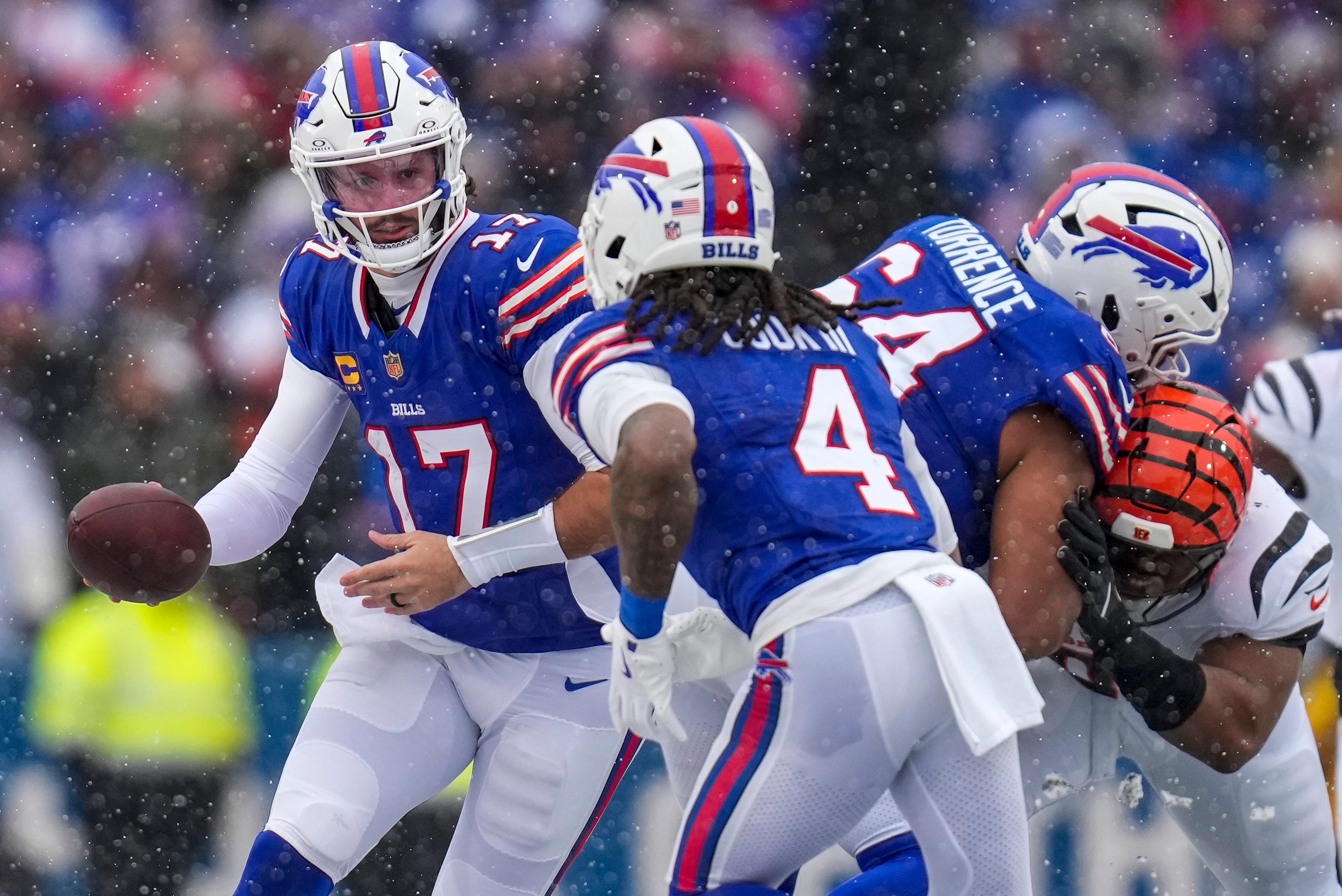 Buffalo Bills quarterback Josh Allen (17) hands off to running back James Cook III (4) in the second quarter of the NFL Week 14 game between the Buffalo Bills and the Cincinnati Bengals at Highmark Stadium in Orchard Park, N.Y., on Sunday, Dec. 7, 2025.