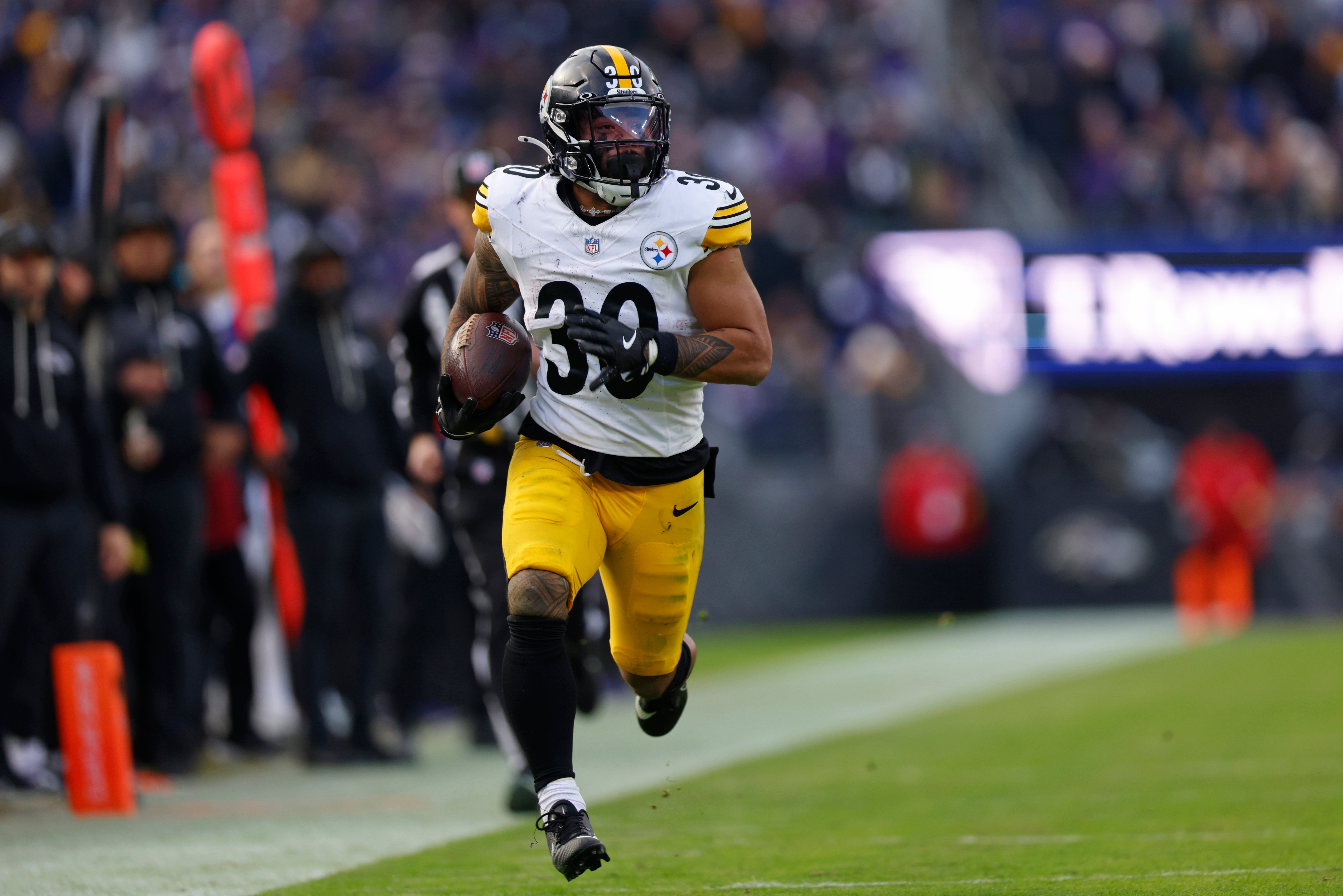 Dec 7, 2025; Baltimore, Maryland, USA; Pittsburgh Steelers running back Jaylen Warren (30) runs with the ball for a touchdown against the Baltimore Ravens during the second half at M&T Bank Stadium.