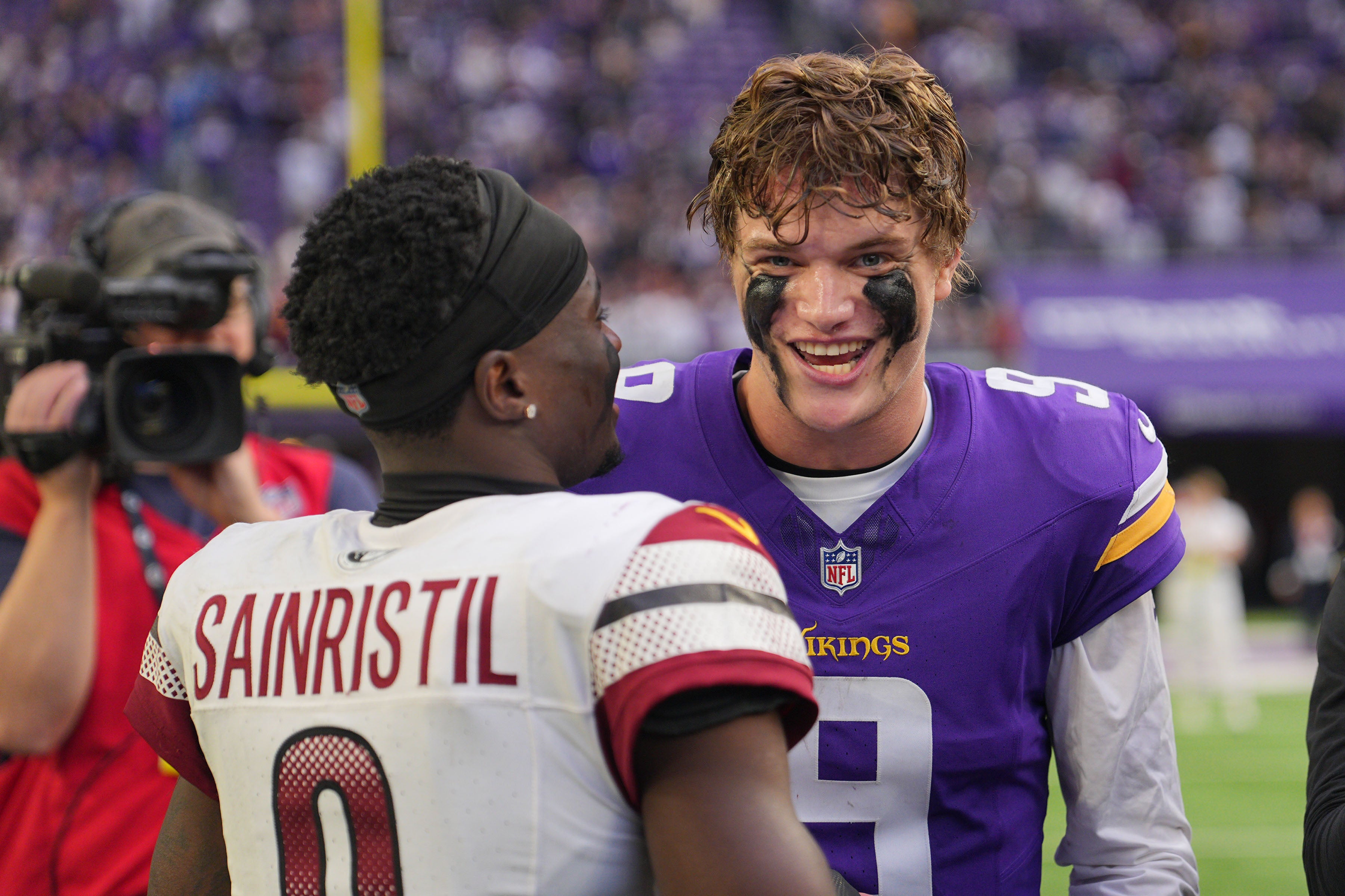 Dec 7, 2025; Minneapolis, Minnesota, USA; Minnesota Vikings quarterback J.J. McCarthy (9) reacts with Washington Commanders cornerback Mike Sainristil (0) after the game at U.S. Bank Stadium.
