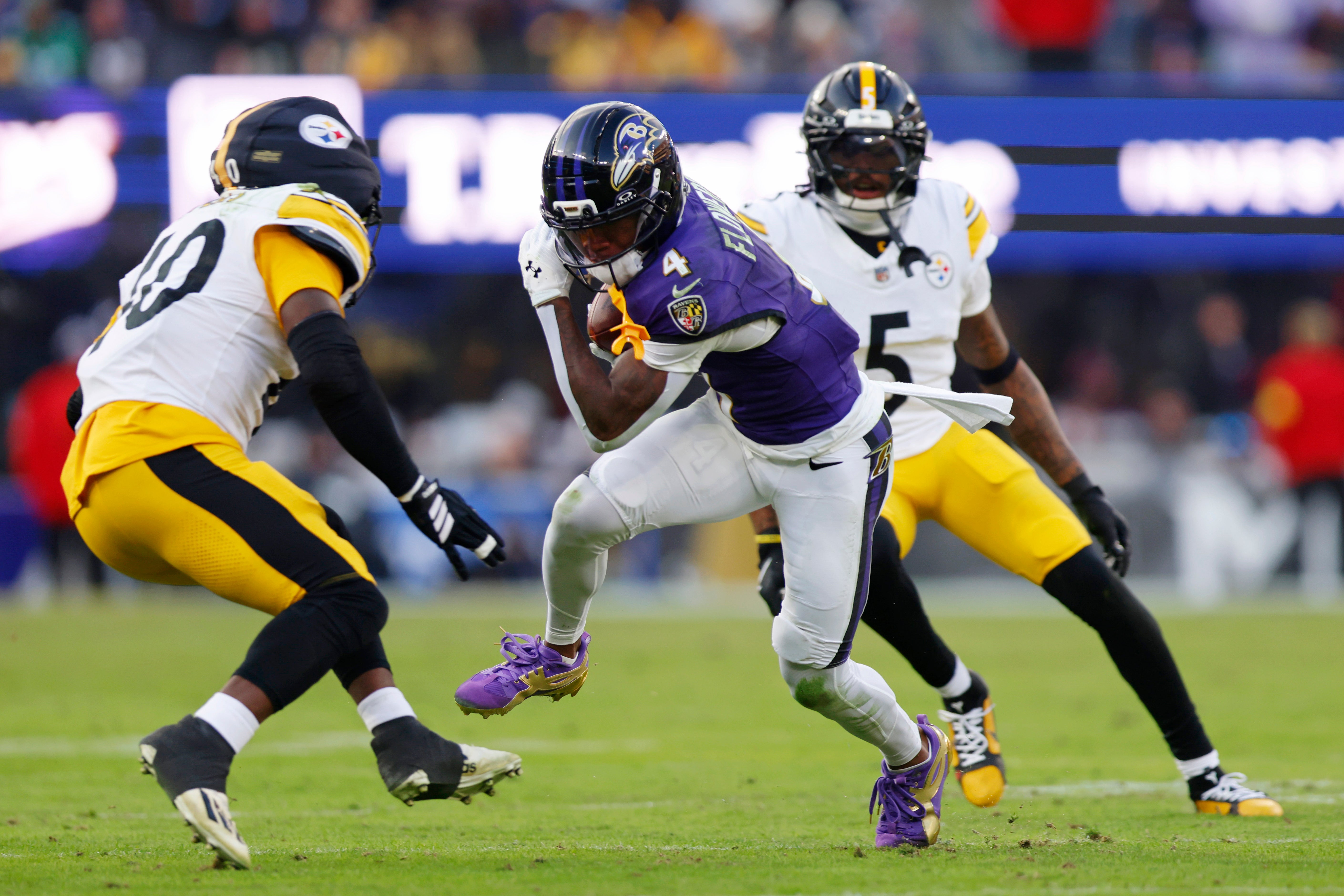 Dec 7, 2025; Baltimore, Maryland, USA; Baltimore Ravens wide receiver Zay Flowers (4) runs with the ball after making a catch against the Pittsburgh Steelers during the second half at M&T Bank Stadium.
