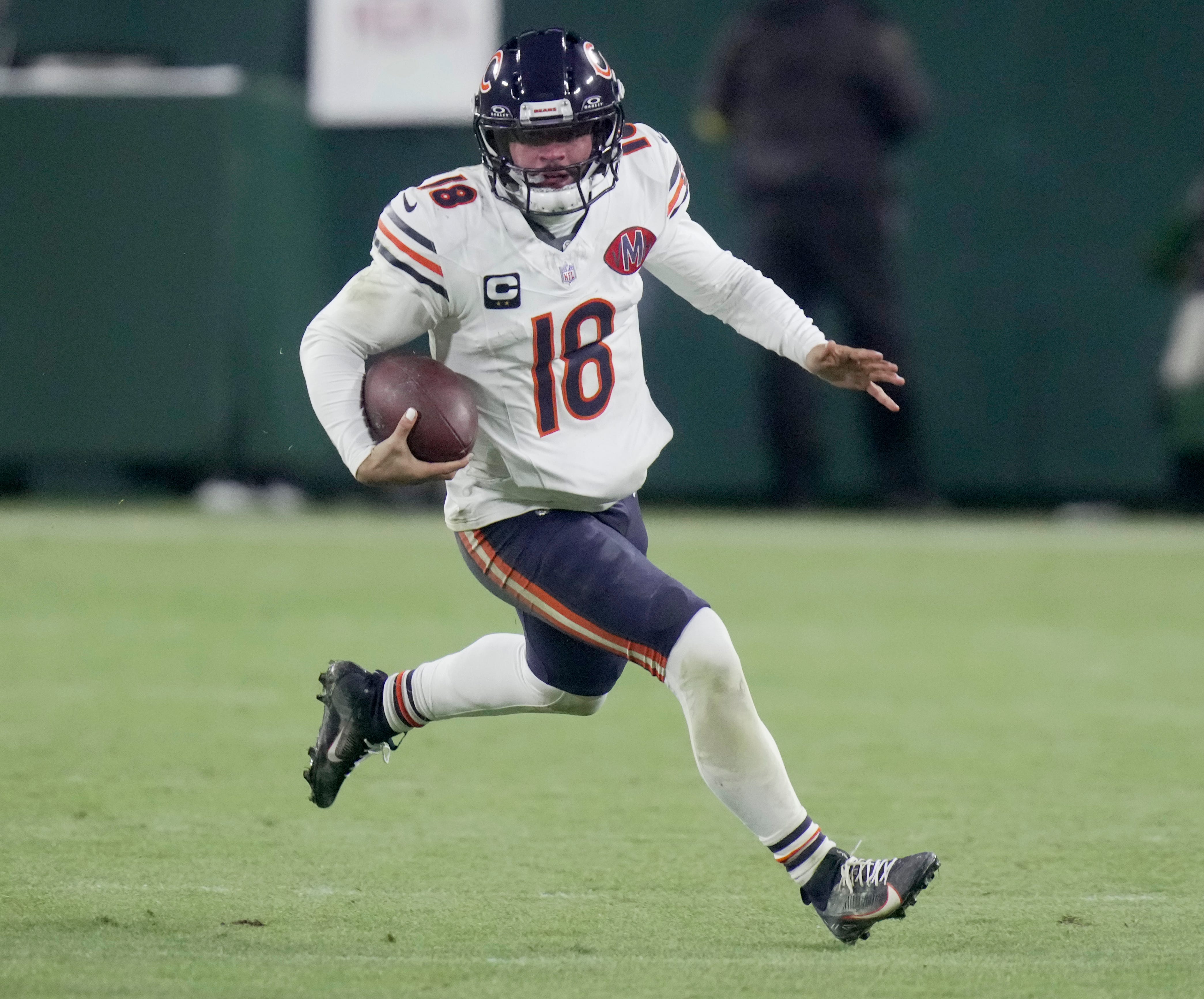 Chicago Bears quarterback Caleb Williams (18) runs for a first down during the third quarter of their game against the Green Bay Packers Sunday, December 7, 2025 at Lambeau Field in Green Bay, Wisconsin.