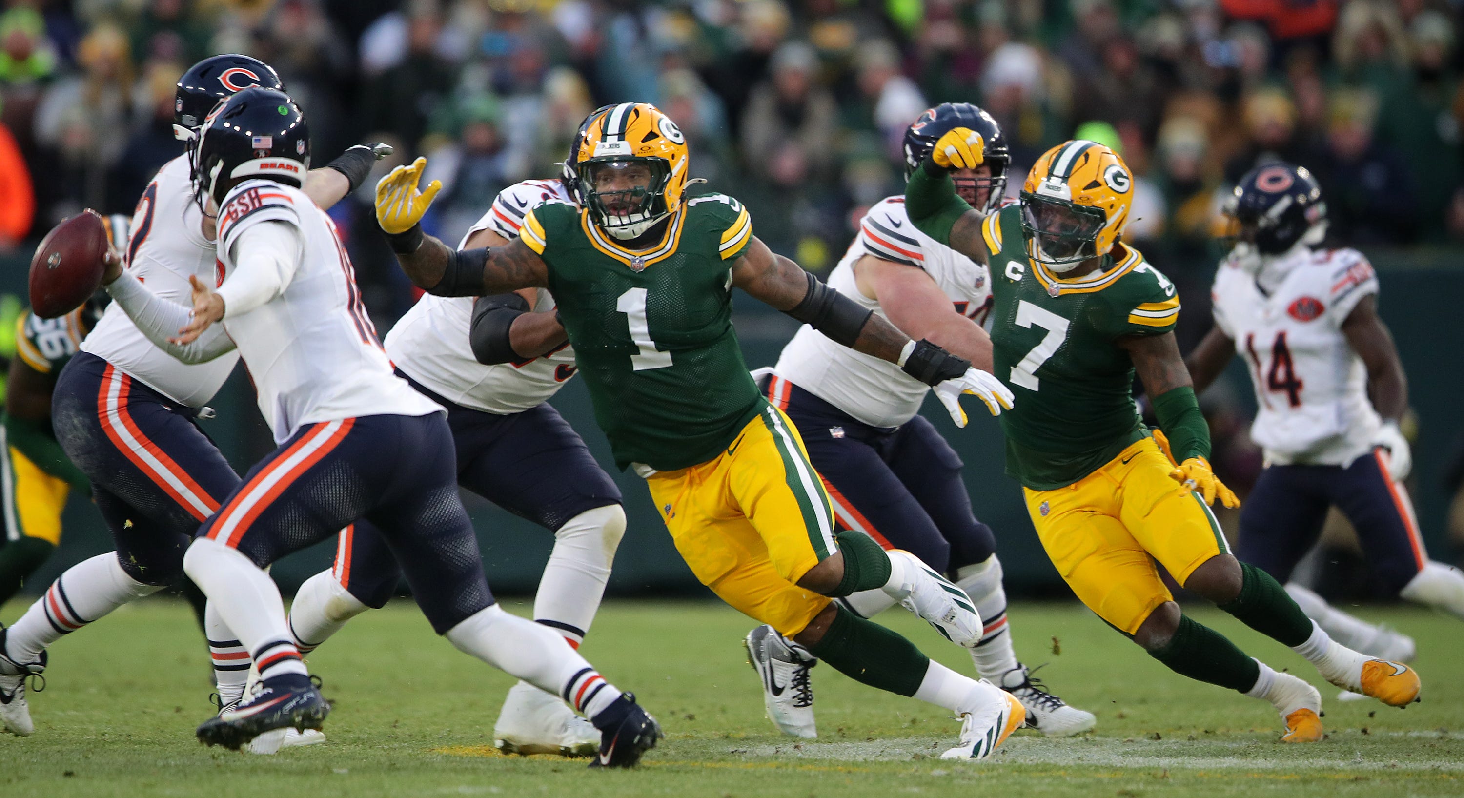 Green Bay Packers defensive end Micah Parsons (1) and linebacker Quay Walker (7) pressure Chicago Bears cornerback Jaylon Johnson (1) on Sunday, December 7, 2025, at Lambeau Field in Green Bay, Wis. The Packers defeated the Bears 28-21.