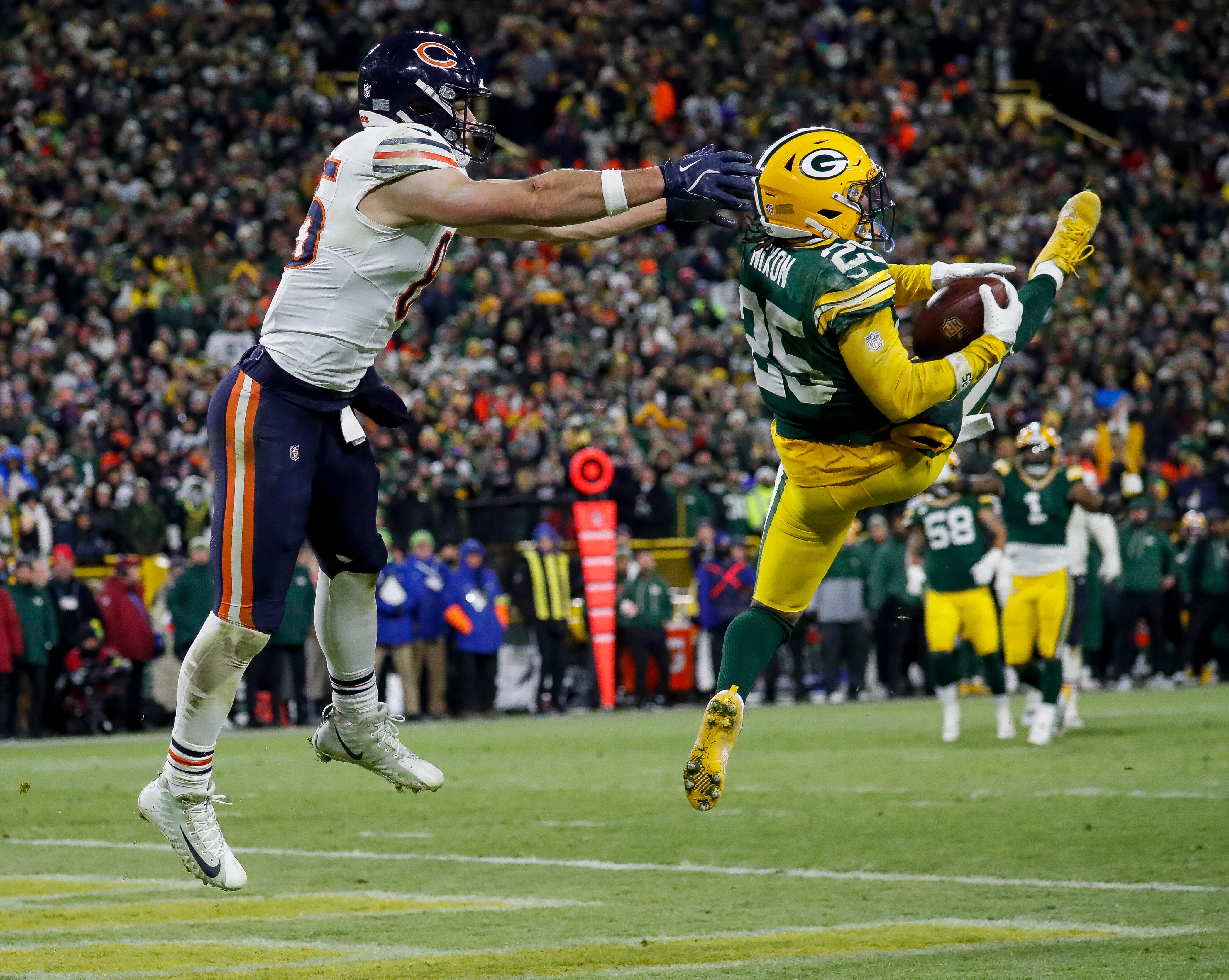 Green Bay Packers cornerback Keisean Nixon (25) intercepts a pass intended for Chicago Bears tight end Cole Kmet (85) in the end zone to seal a victory on Sunday, December 7, 2025, at Lambeau Field in Green Bay, Wis. The Packers won the game, 28-21.
